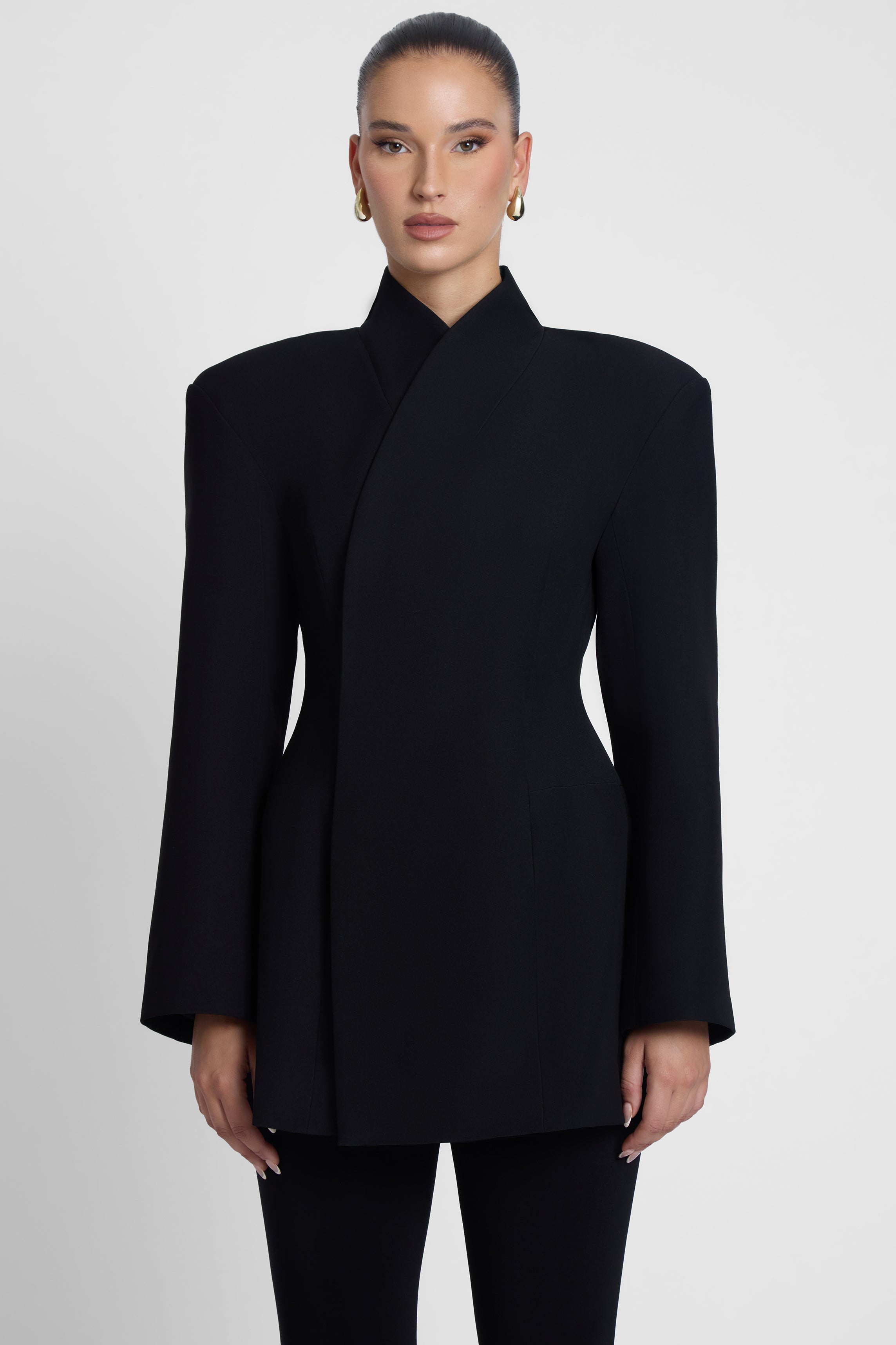 Model is wearing Cairo Hourglass Belted Coat Black, front view.