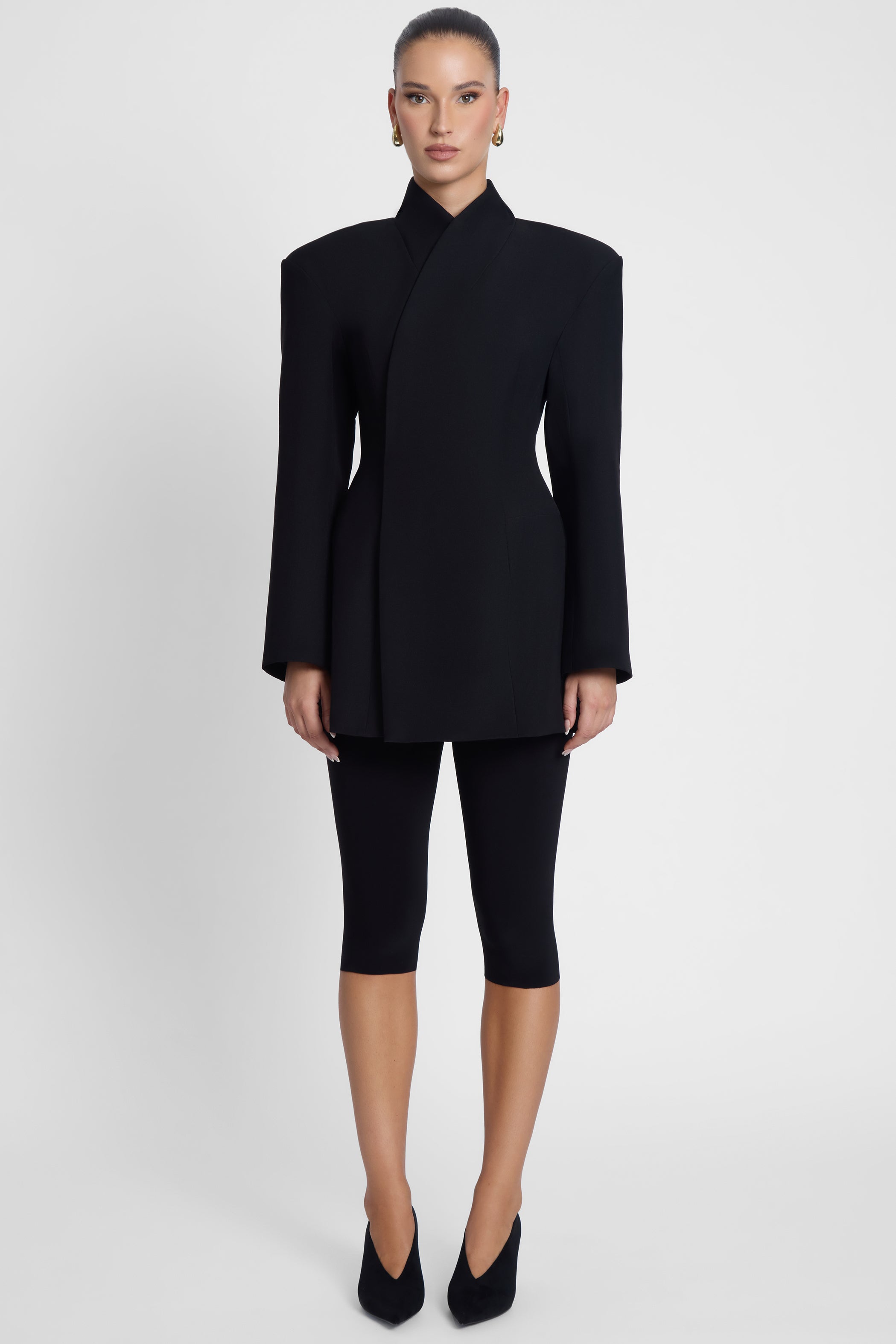 Model is wearing Cairo Hourglass Belted Coat Black, front view.