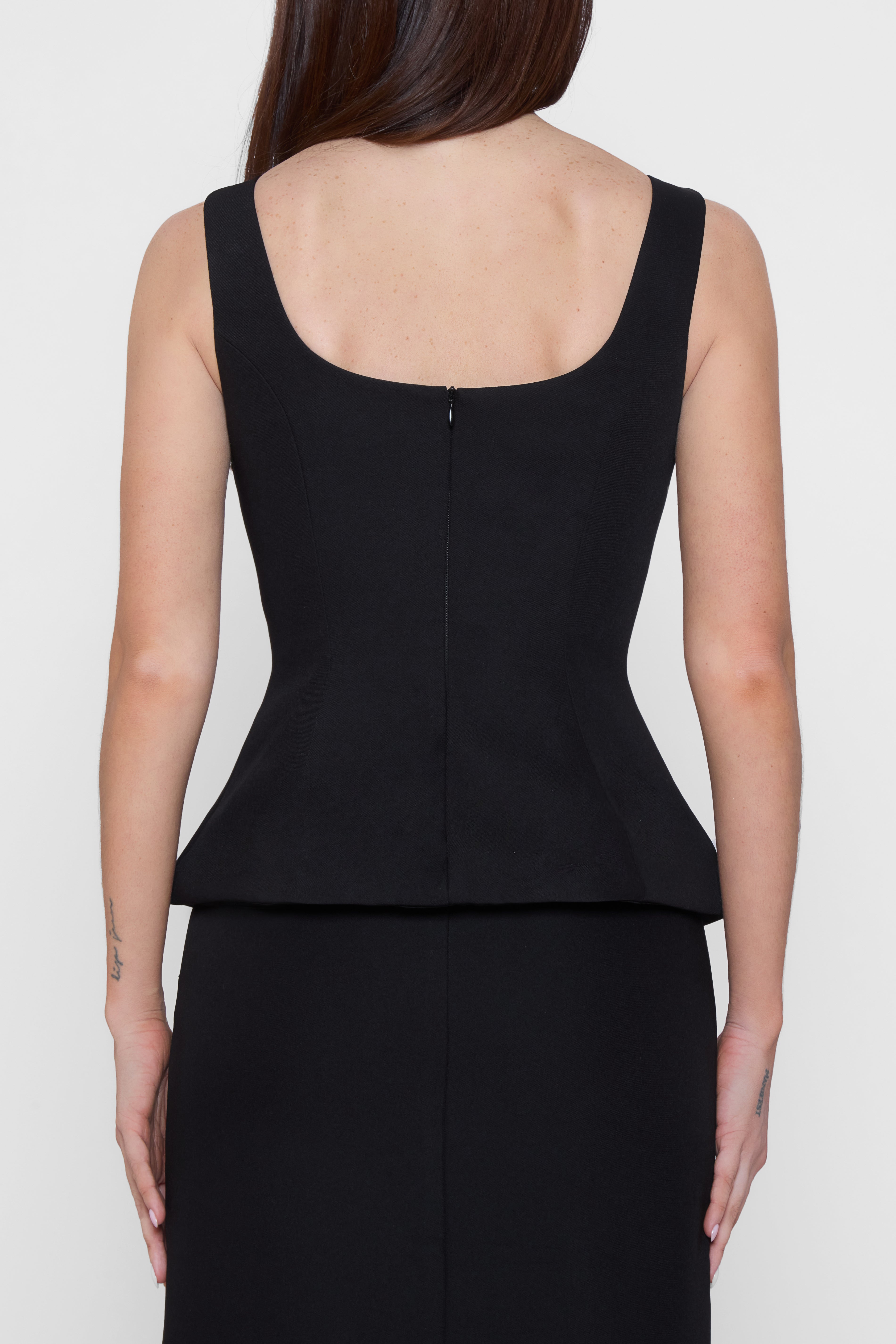 Model wearing LEAU Calesia Contour Bustier Top in Black, back view.