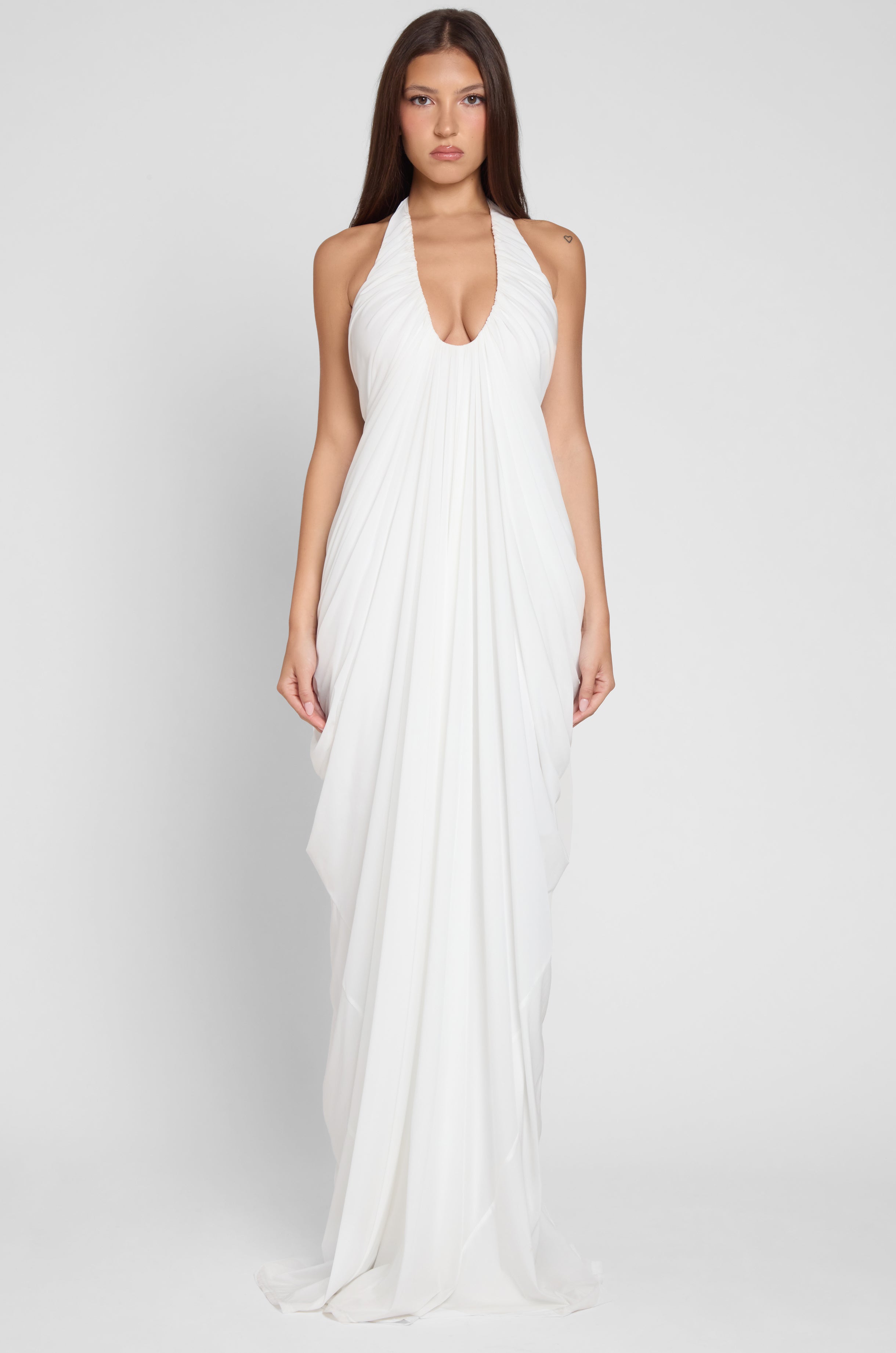 Model is wearing Cascade Drape Gown in White, front view.