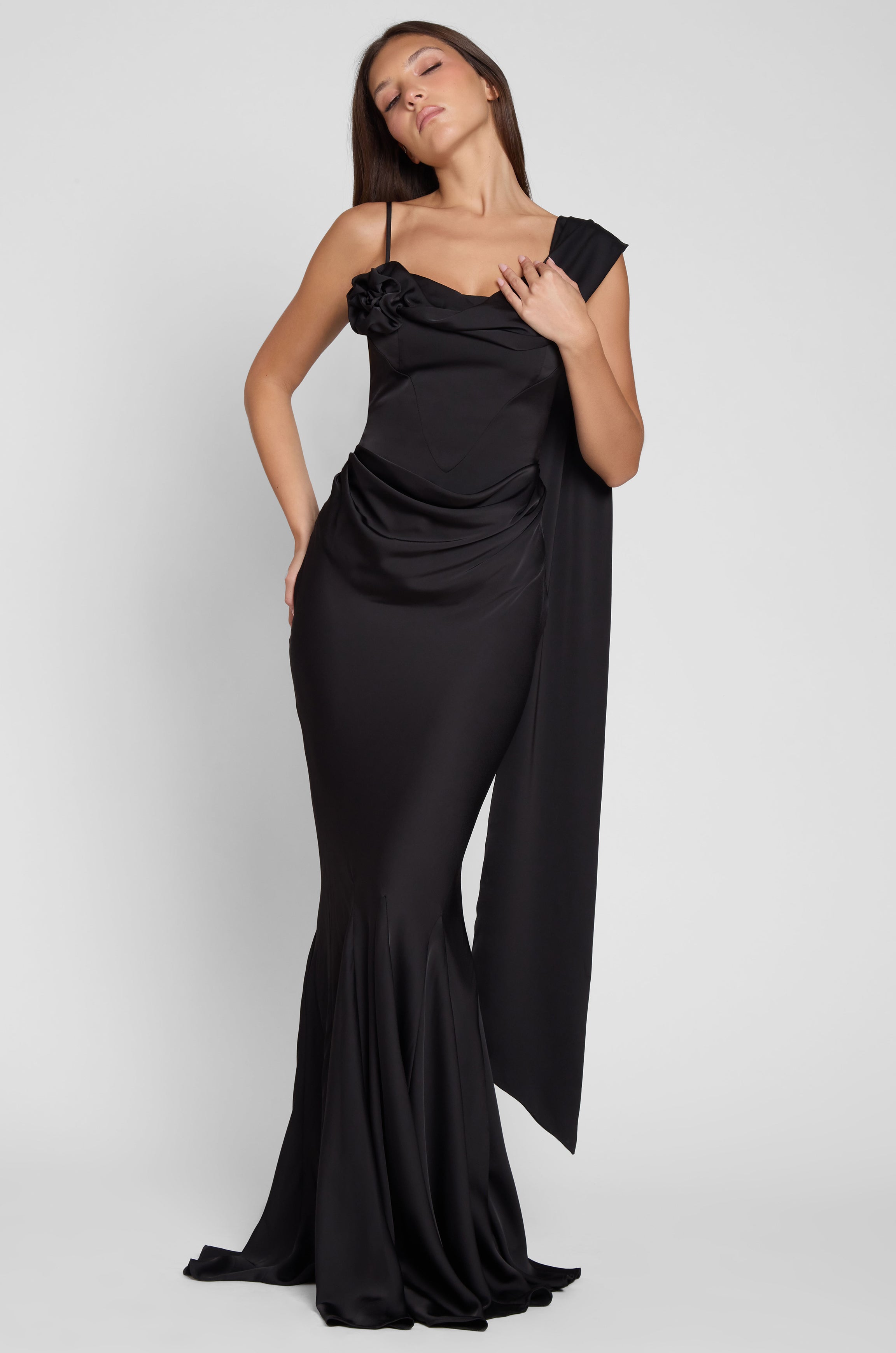 Model is wearing Celine Corset Drape Satin Gown in Black, front view.