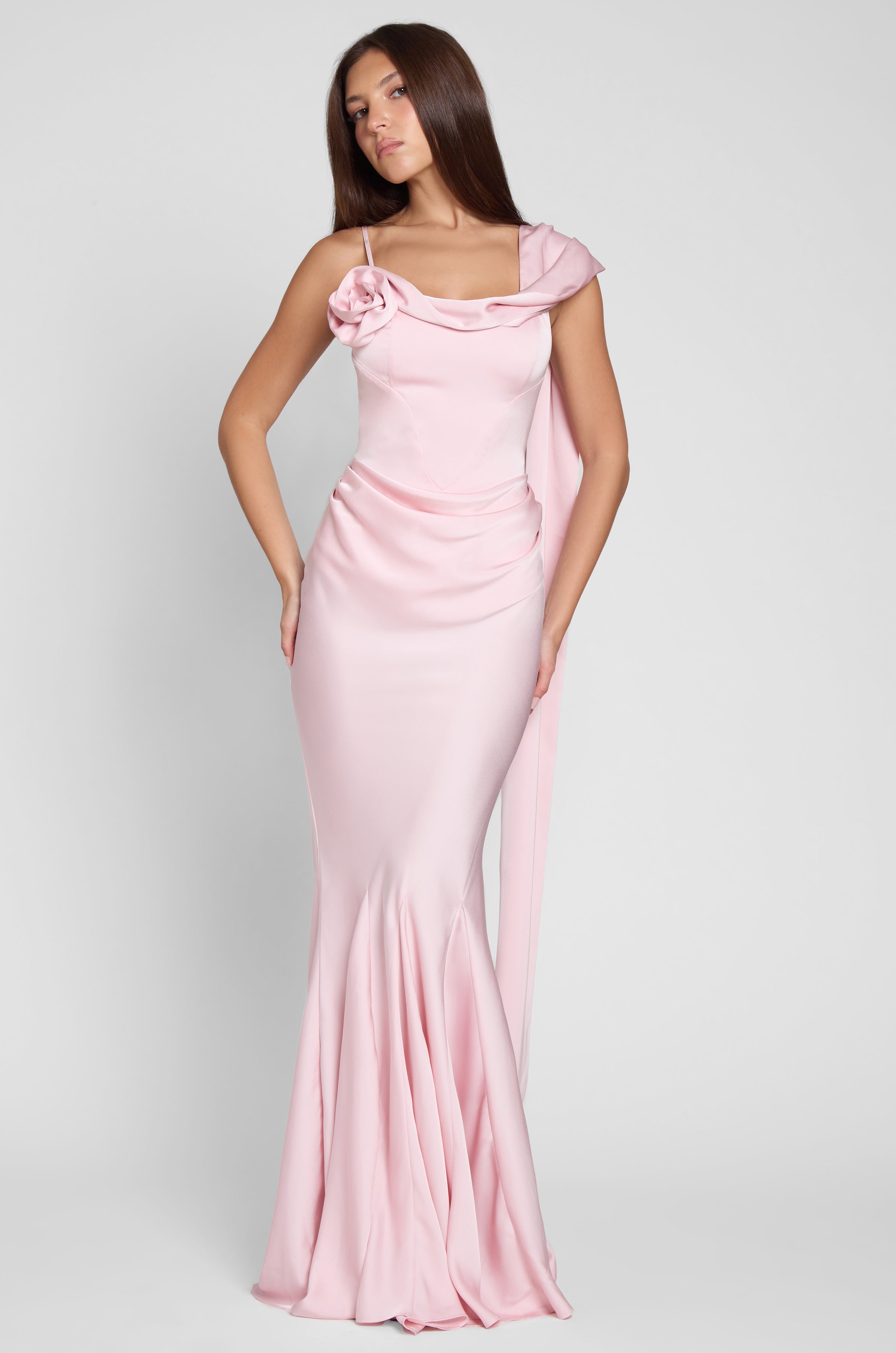 Model is wearing Celine Corset Drape Satin Gown in Pink, front view.
