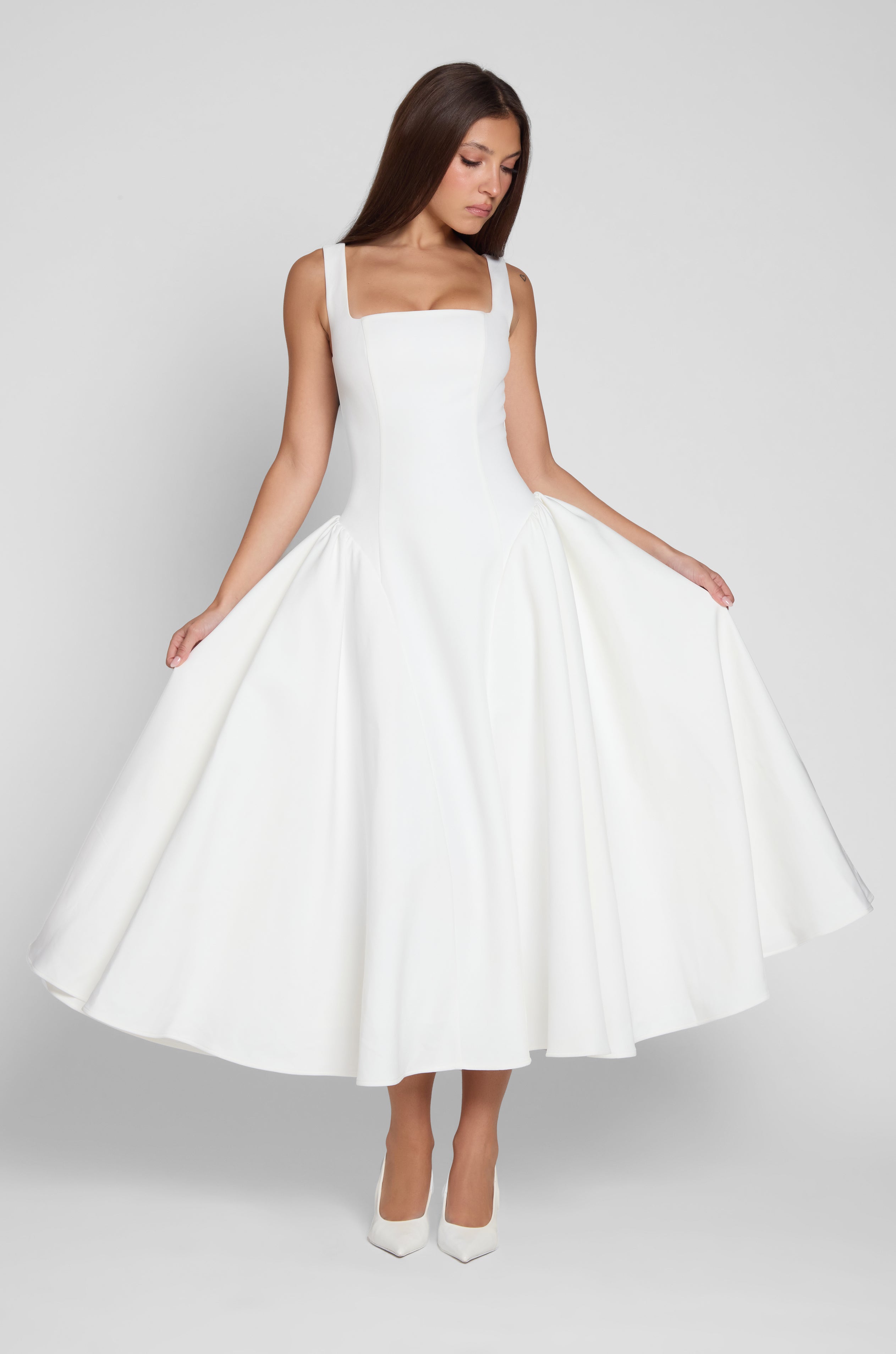 Model is wearing Chloe Corset Midi Dress White, front view.