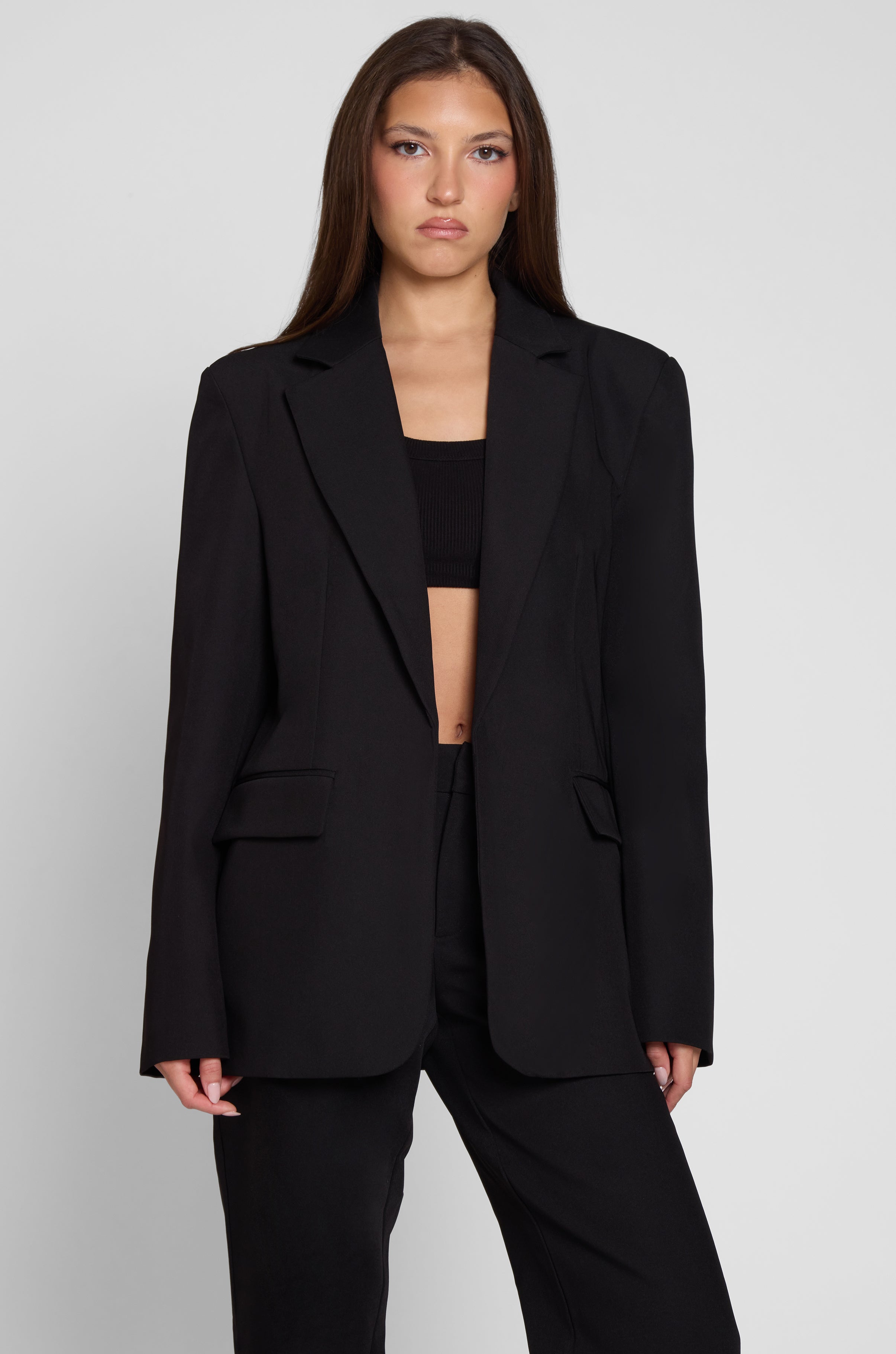 Model is wearing Classic Column Oversized Blazer in Black, front view.