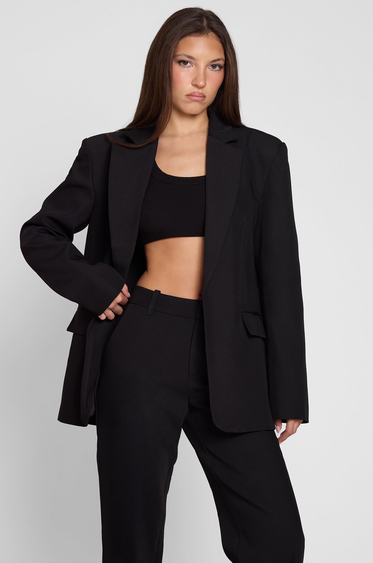 Model is wearing Classic Column Oversized Blazer in Black, front view.