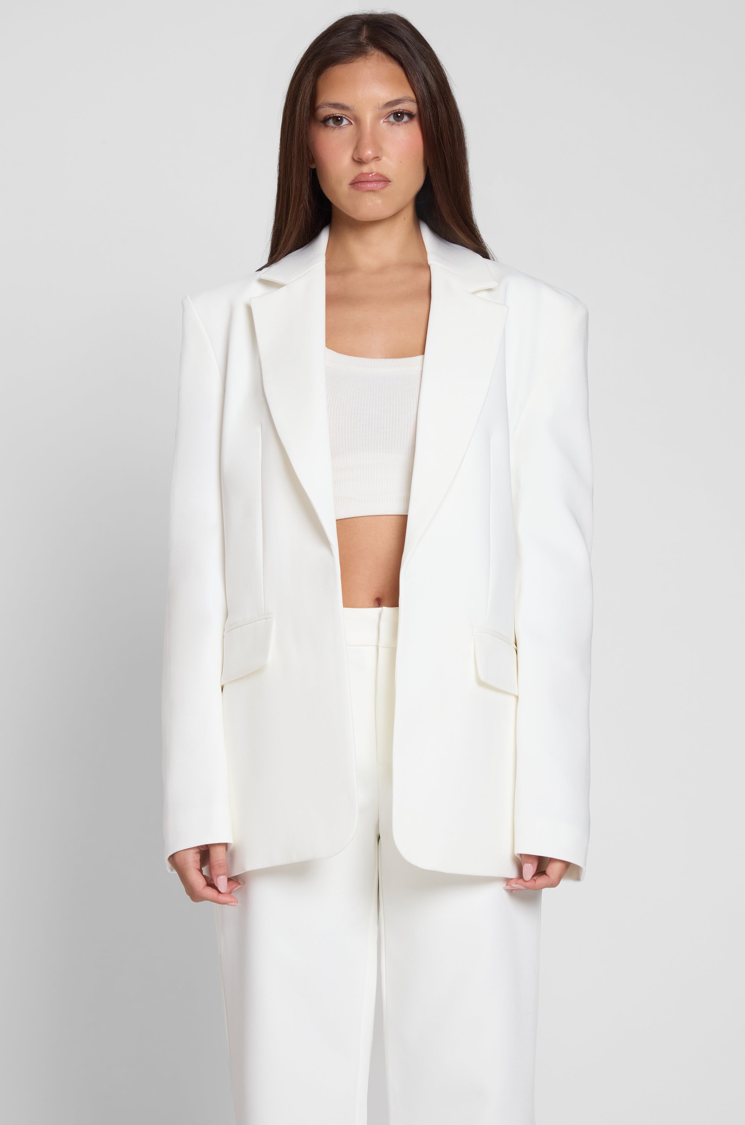 Model is wearing Classic Column Oversized Blazer in White, front view.
