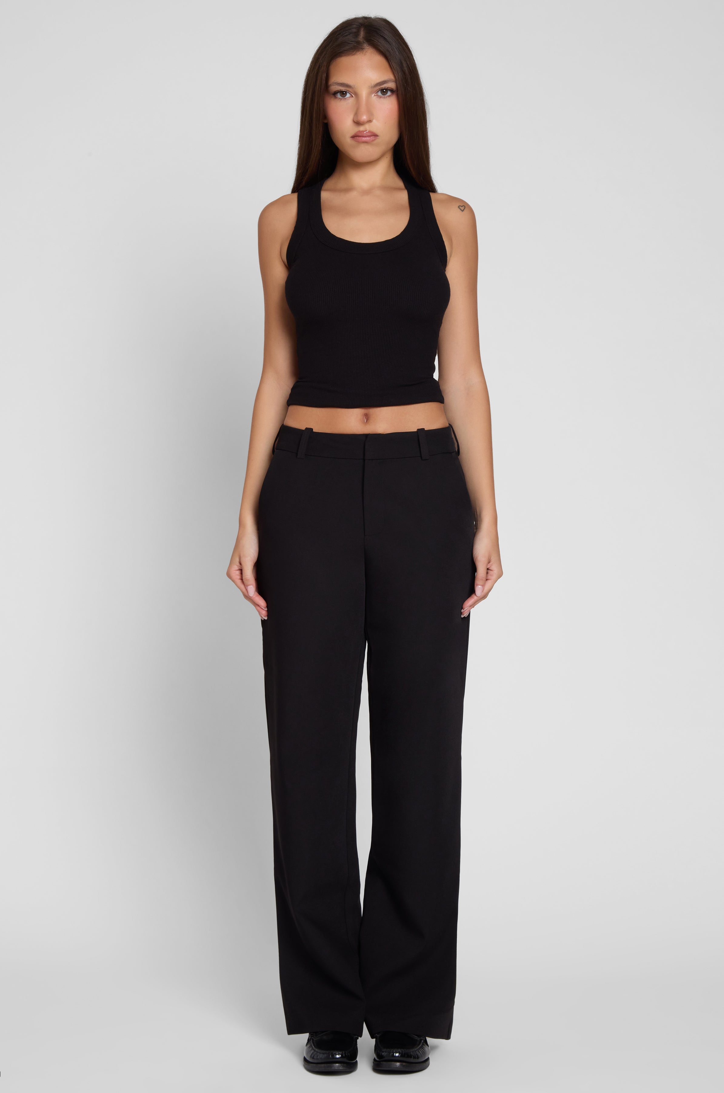 Model is wearing Classic Column Straight Trousers in Black, front view.