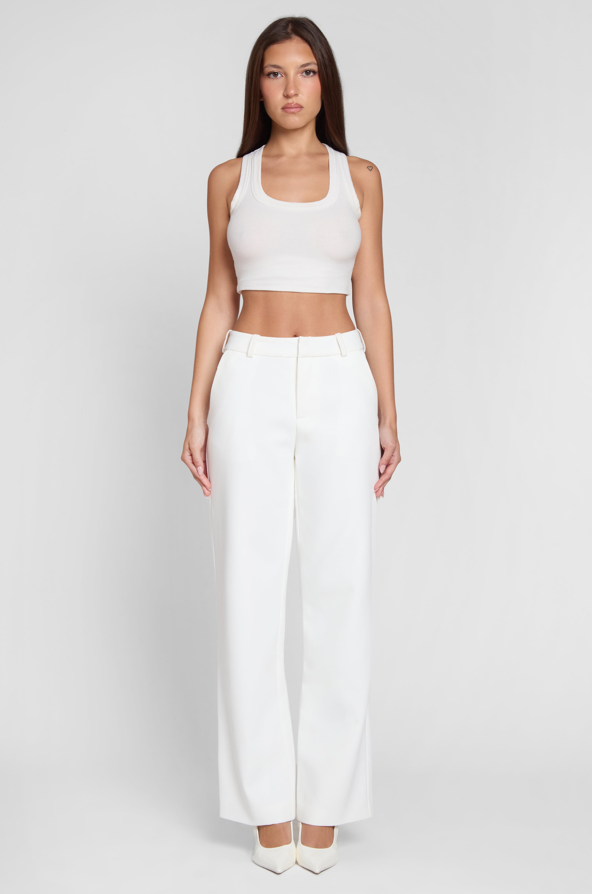 Model wearing Classic Column Straight Trousers in White, front view.