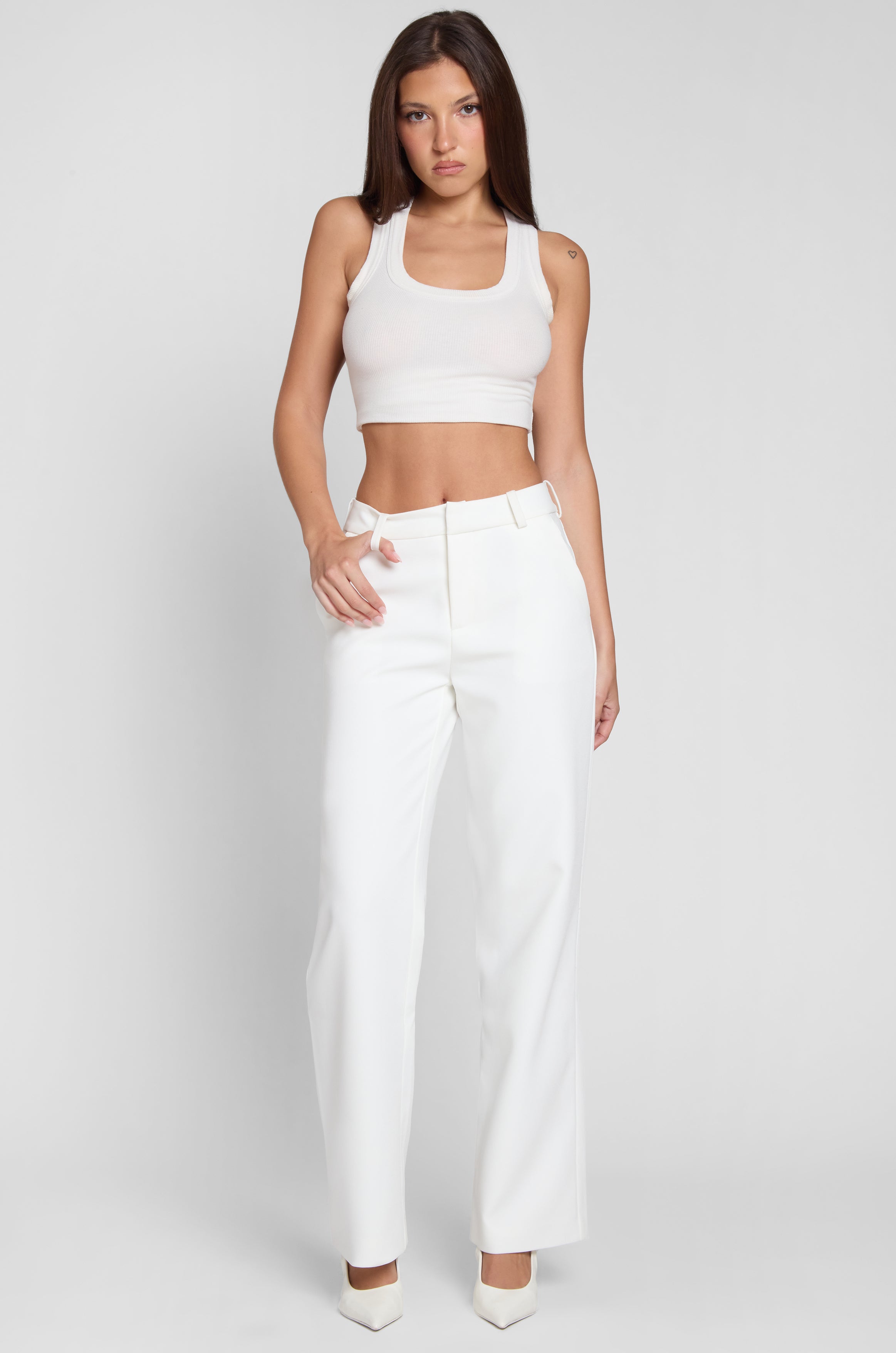 Model wearing Classic Column Straight Trousers in White, front view.
