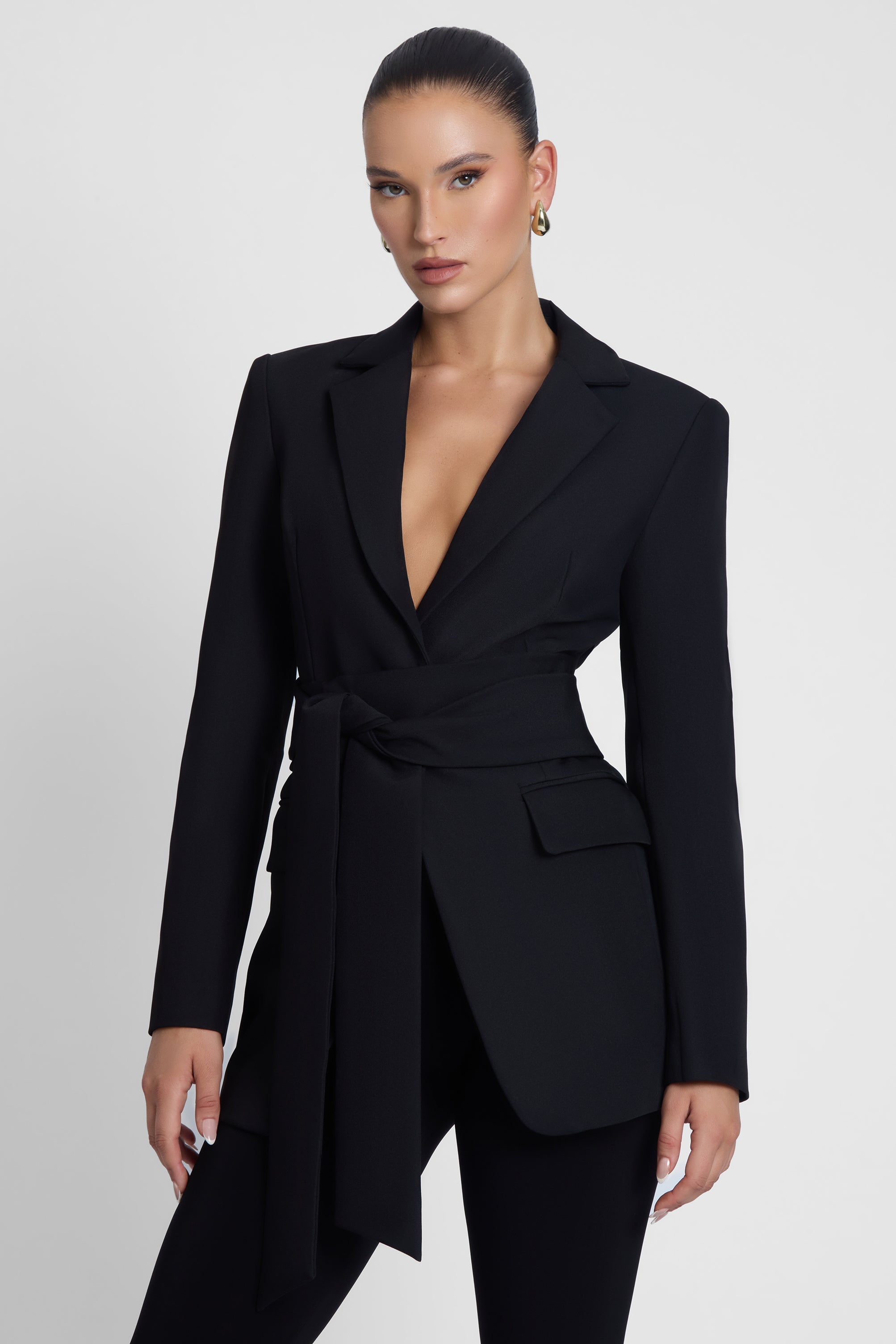 Model is wearing Classic Column Tailored Belted Blazer Black, side view.