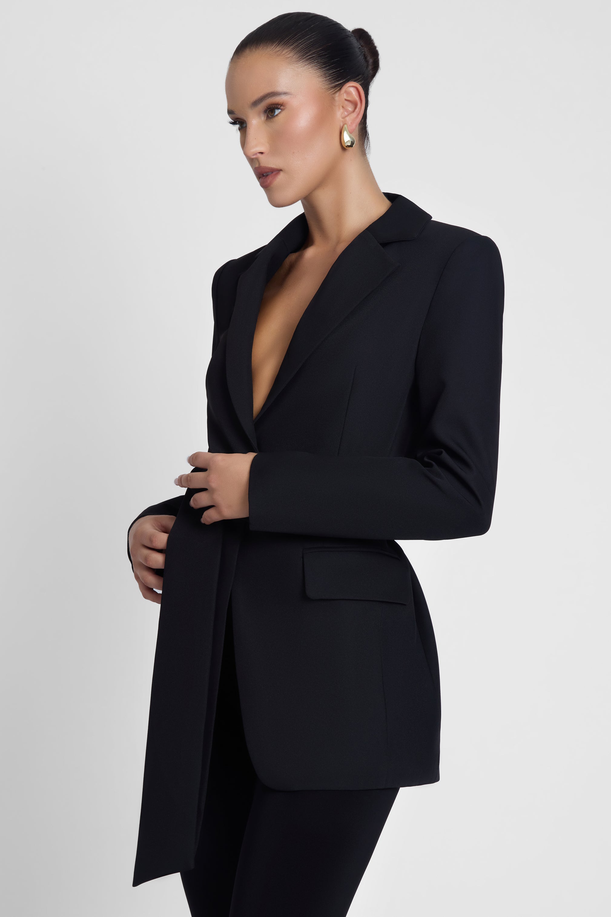 Model is wearing Classic Column Tailored Belted Blazer Black, side view.
