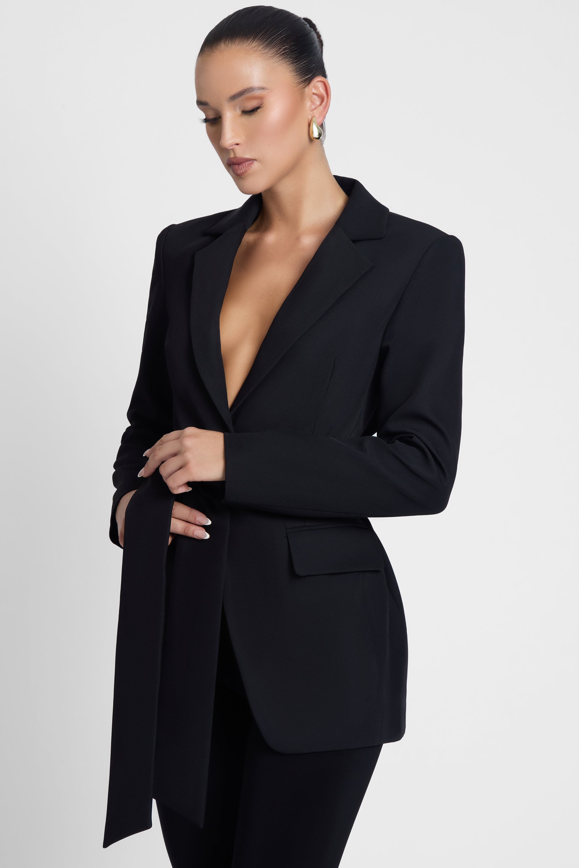 Model is wearing Classic Column Tailored Belted Blazer Black, side view.