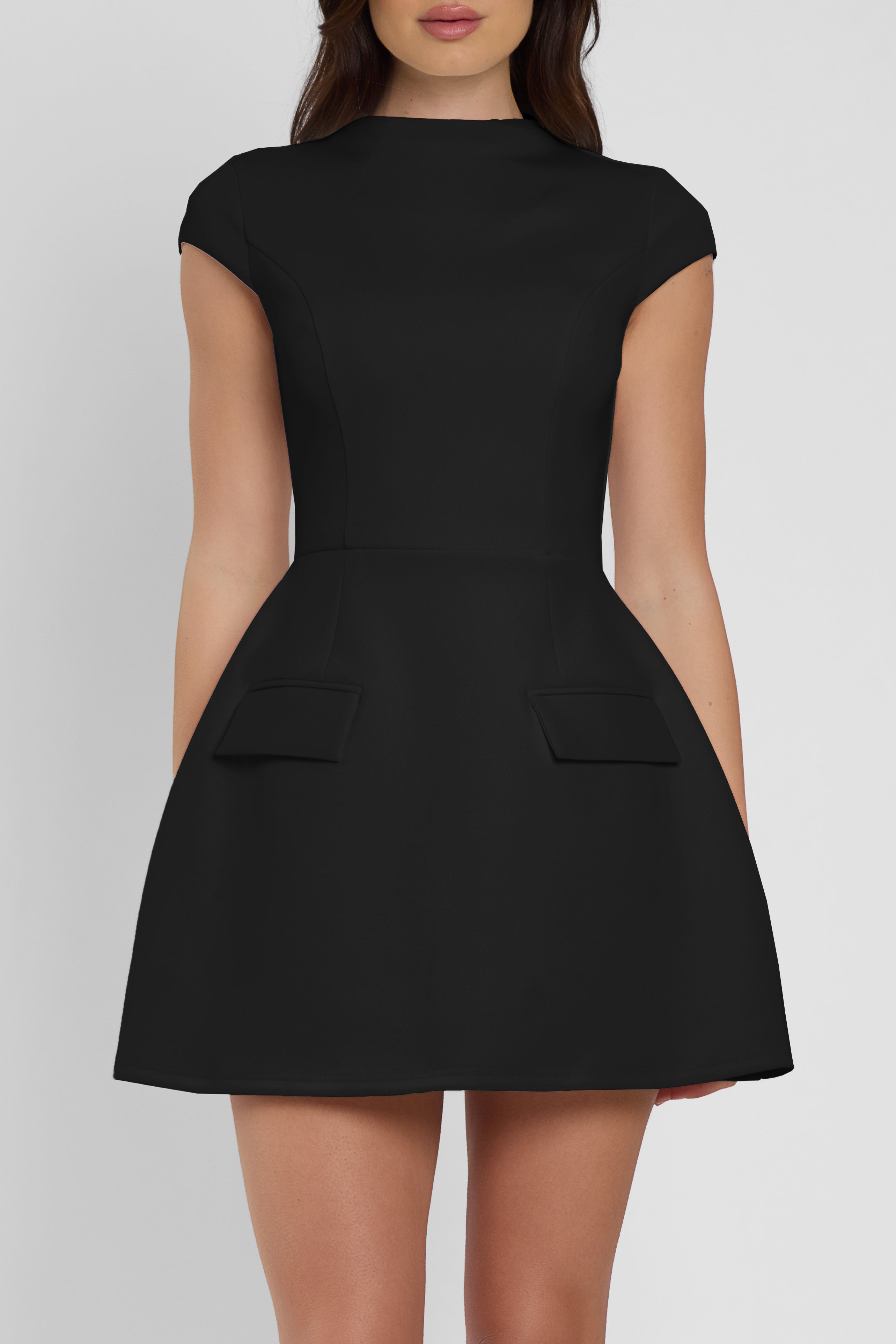 Model wearing Cote Cap Sleeve Pocket Mini Dress in Black, front view.