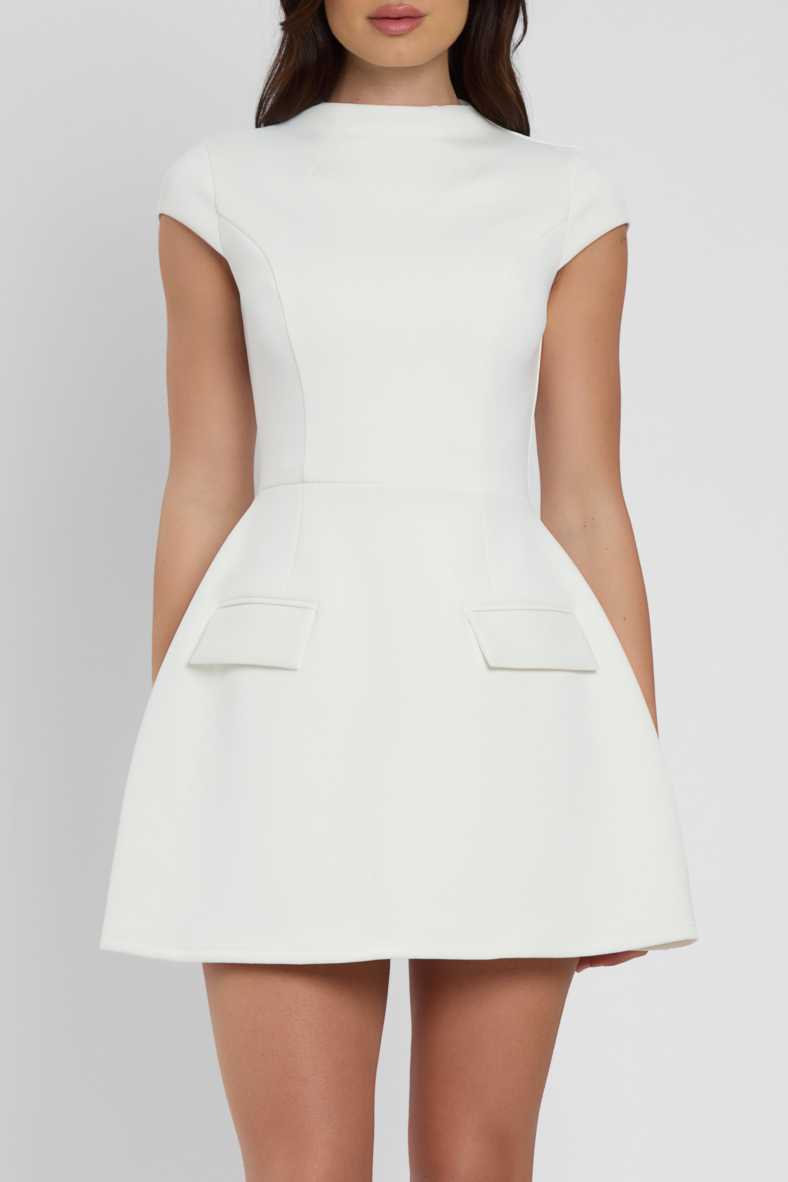 Model wearing Cote Cap Sleeve Pocket Mini Dress in White, front view.