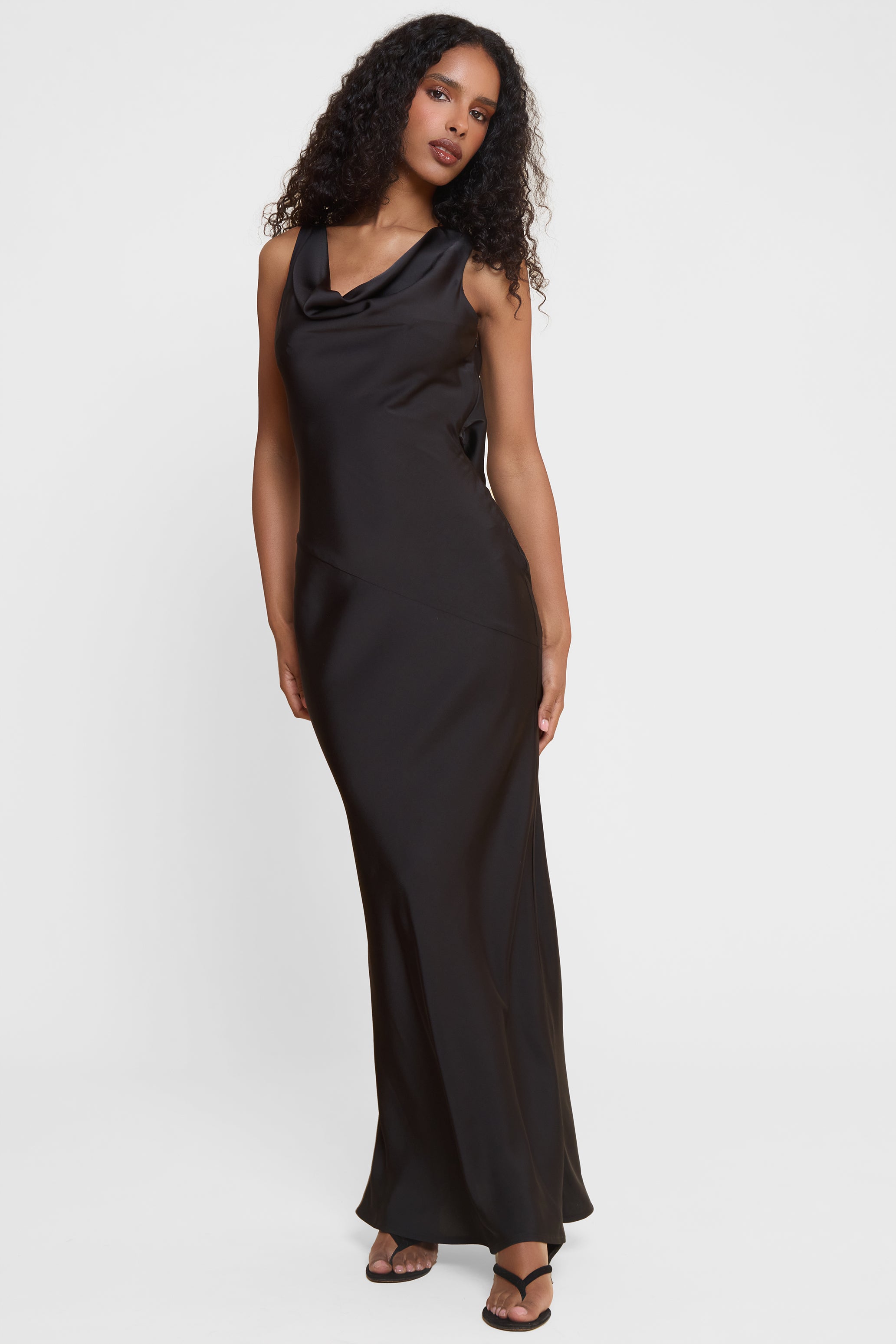 Model wearing Dove Drape Satin Gown in Black, front view.