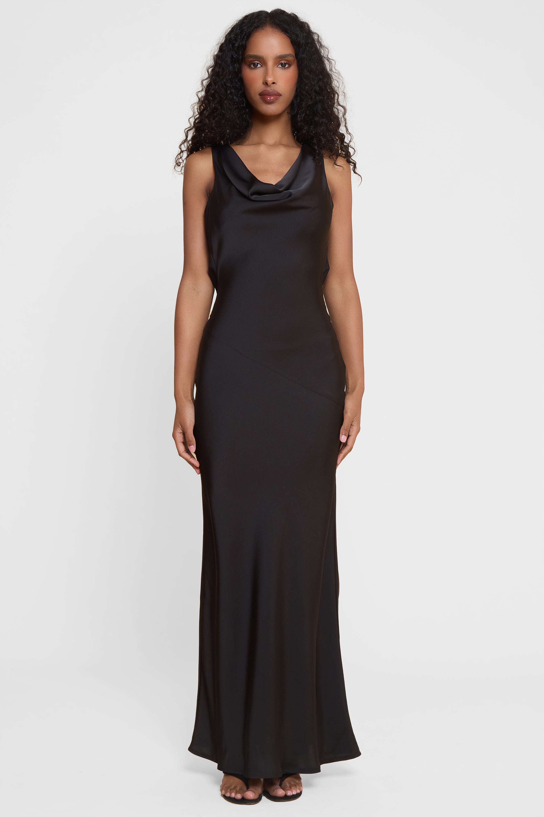 Model wearing Dove Drape Satin Gown in Black, front view.