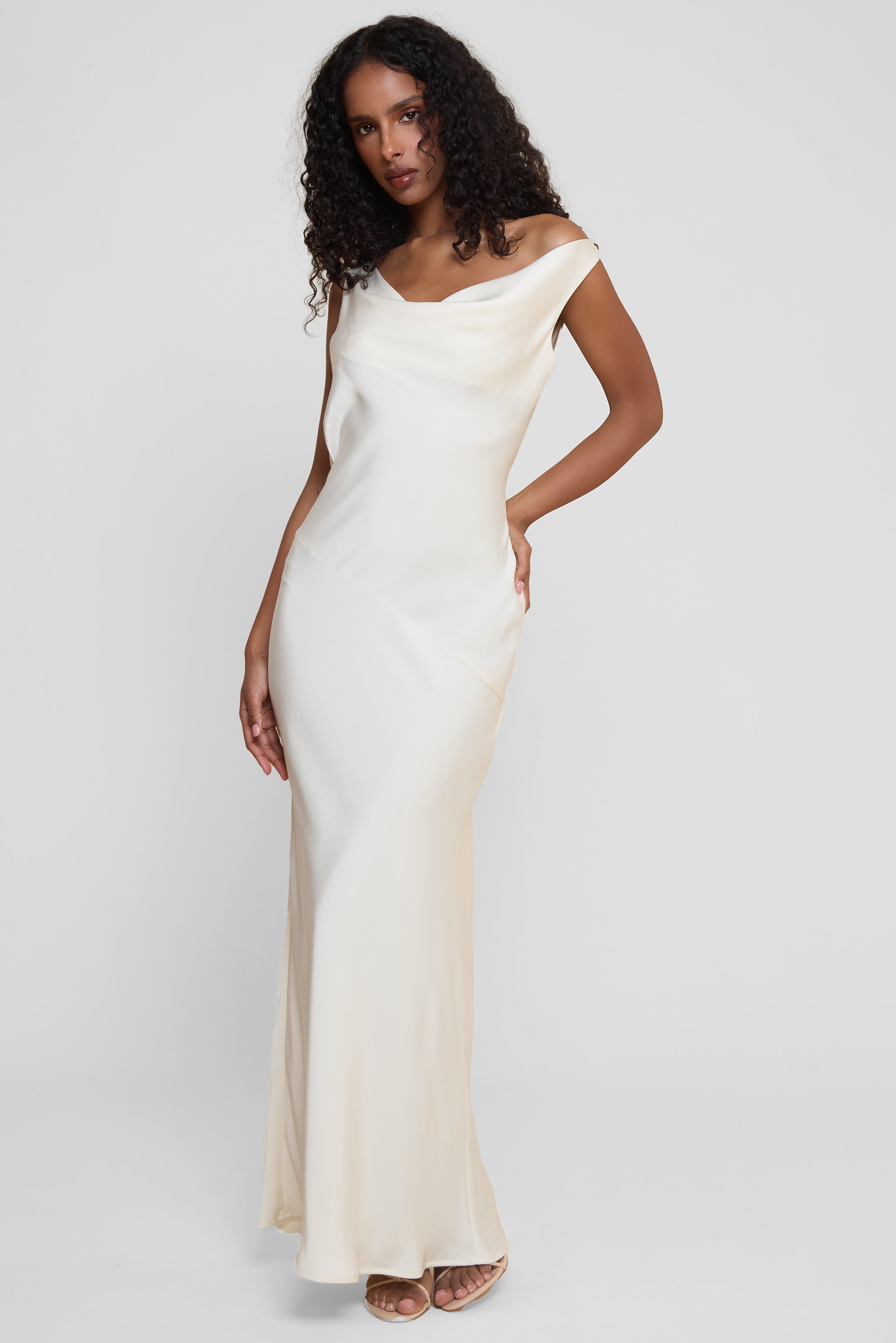 Model wearing Dove Drape Satin Gown in Ivory, front view.