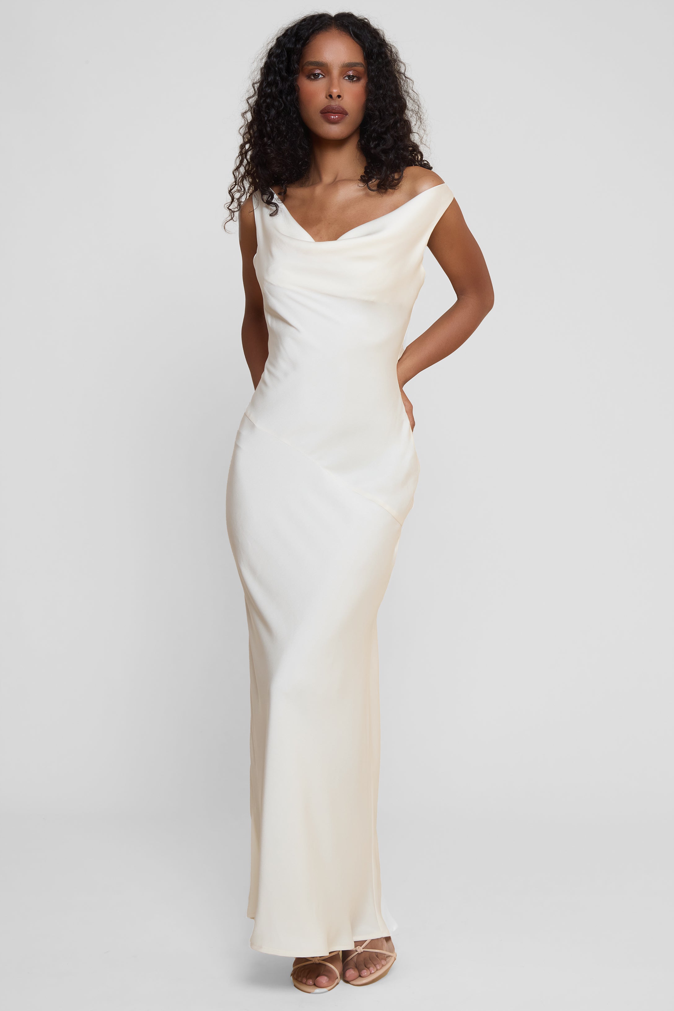 Model wearing Dove Drape Satin Gown in Ivory, front view.