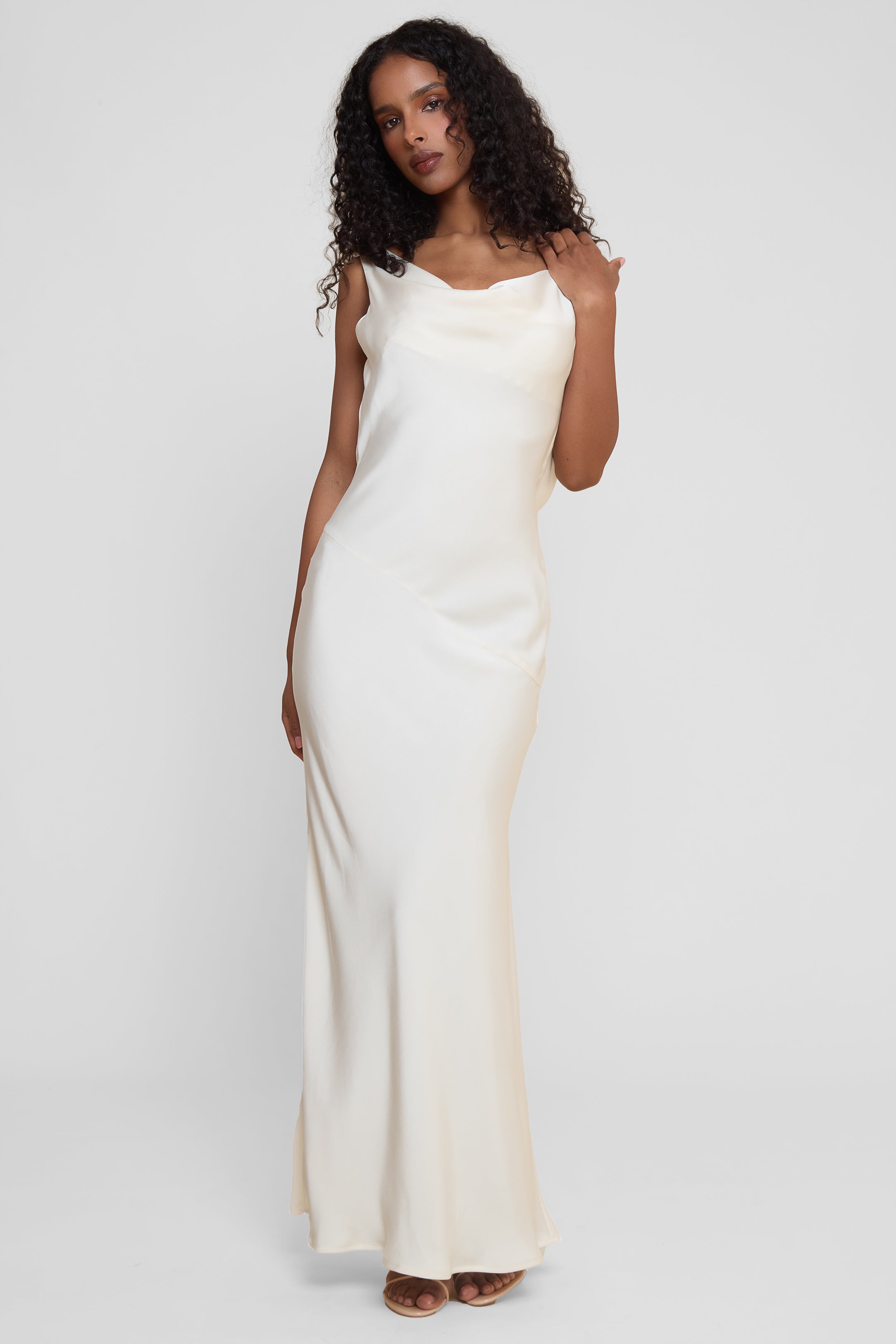 Model wearing Dove Drape Satin Gown in Ivory, front view.