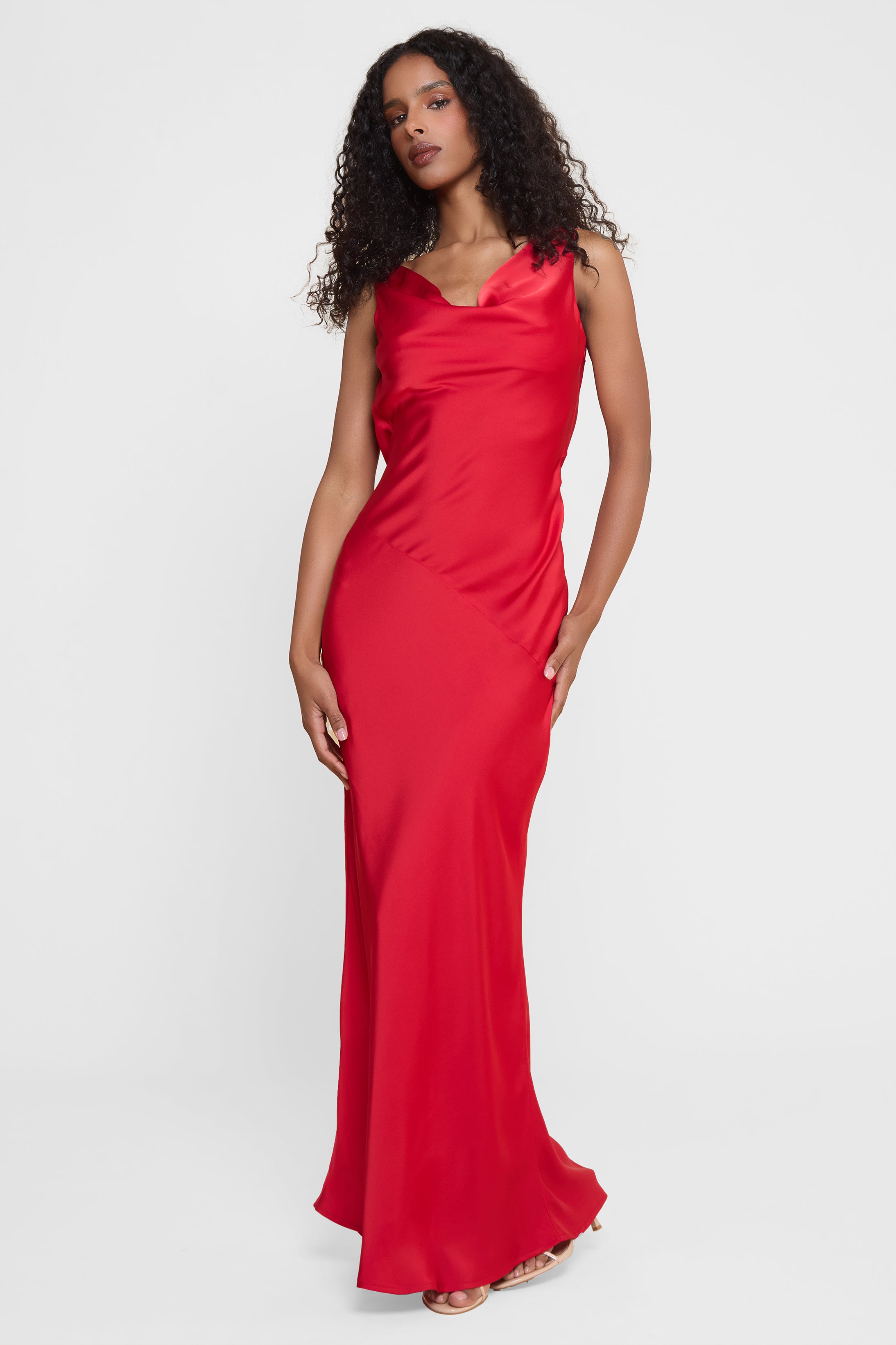 Model wearing Dove Drape Satin Gown in Red, front view.