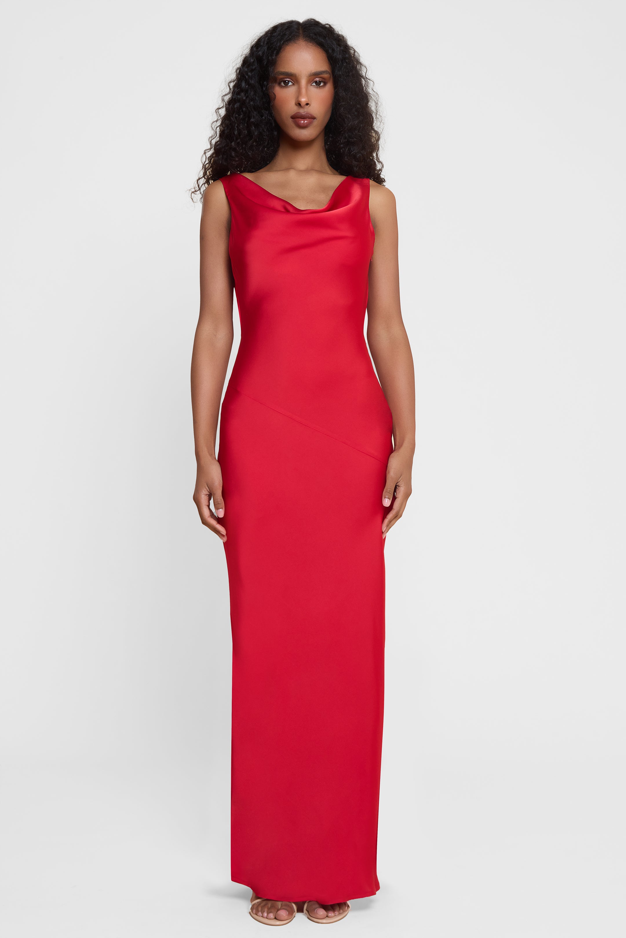Model wearing Dove Drape Satin Gown in Red, front view.