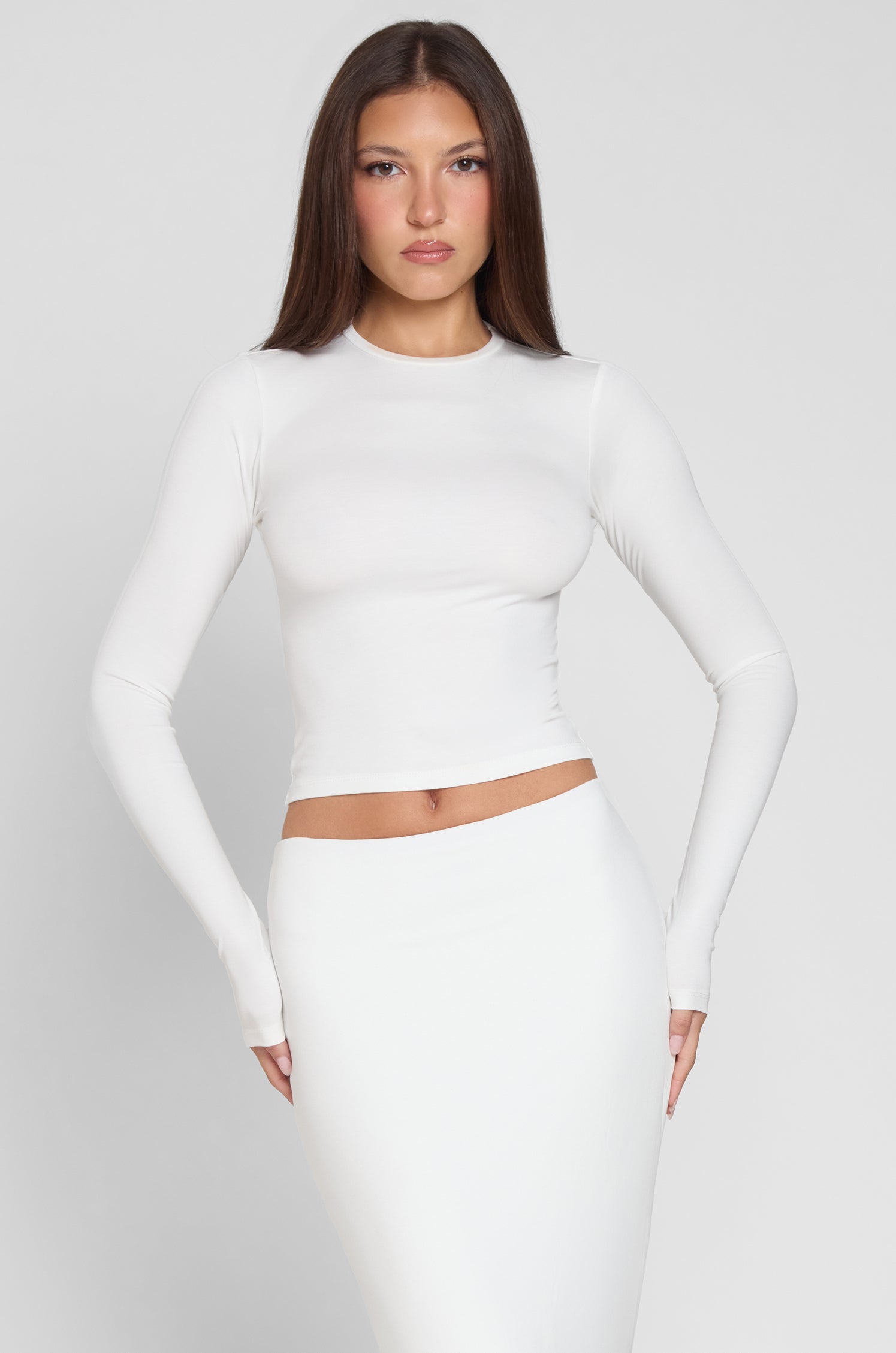 Model is wearing Everyday Jersey Long Sleeve Top in White, front view.