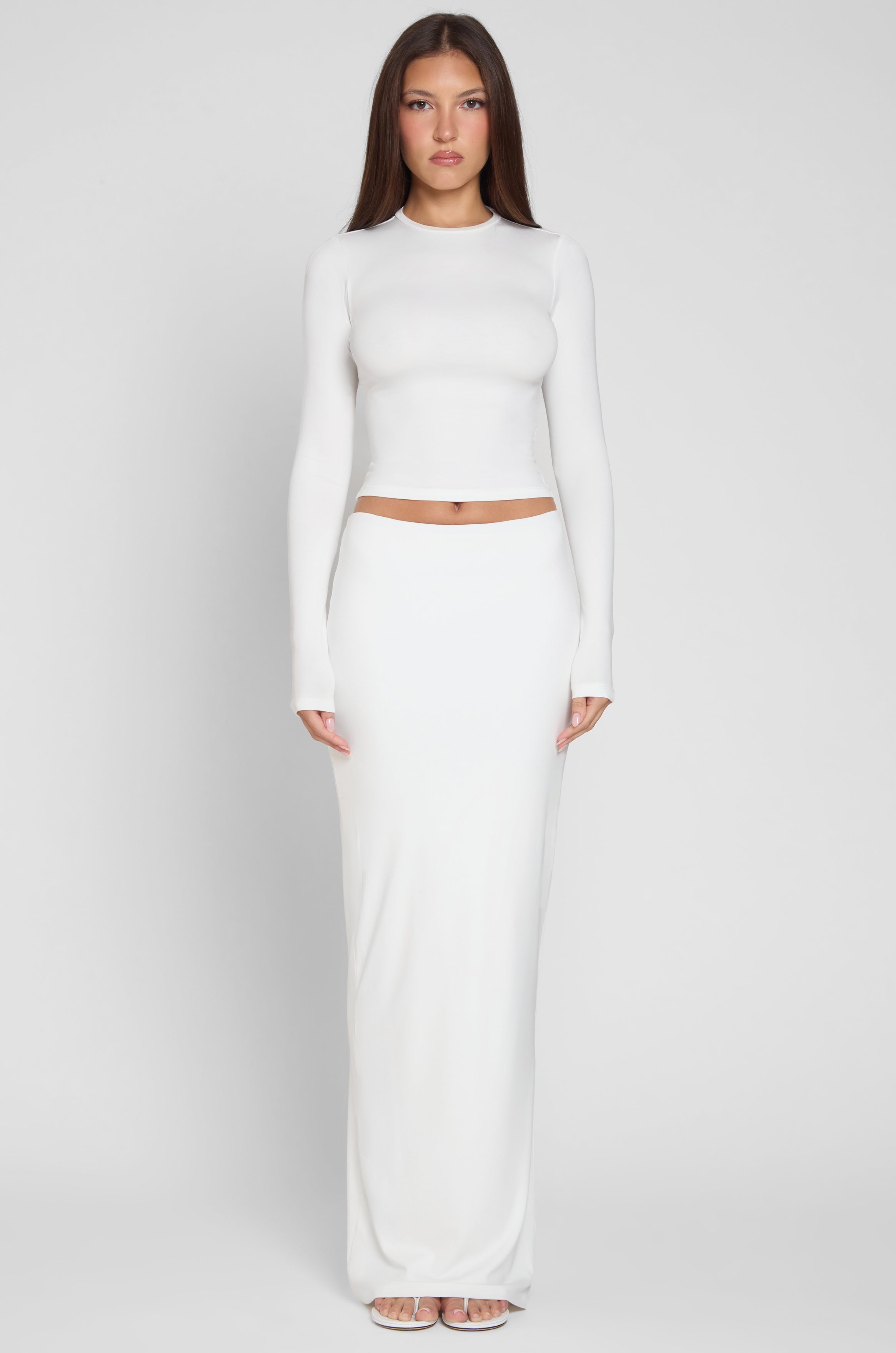 Model is wearing Everyday Jersey Long Sleeve Top in White, front view.