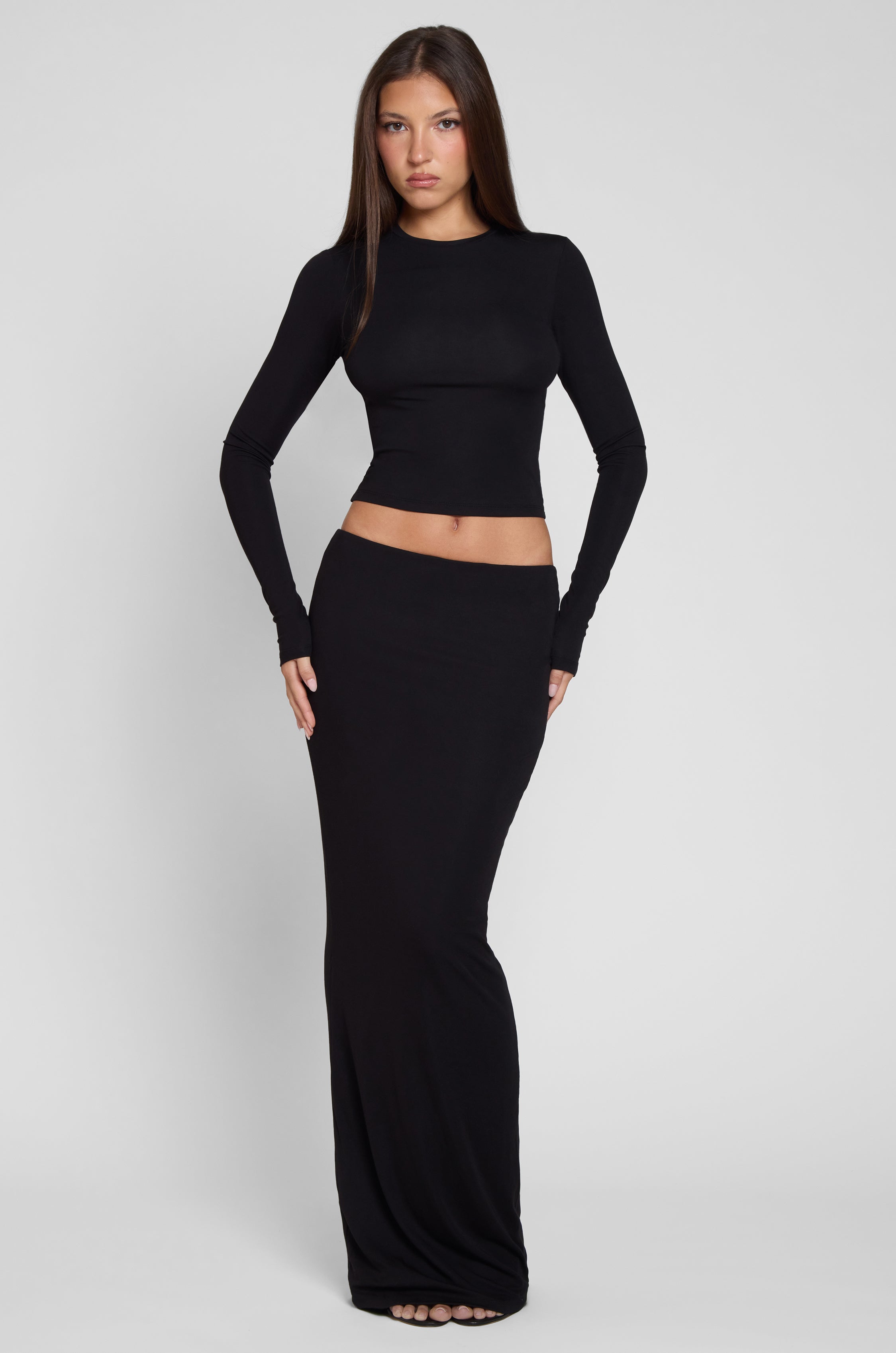 Model is wearing Everyday Jersey Maxi Skirt in Black, front view.