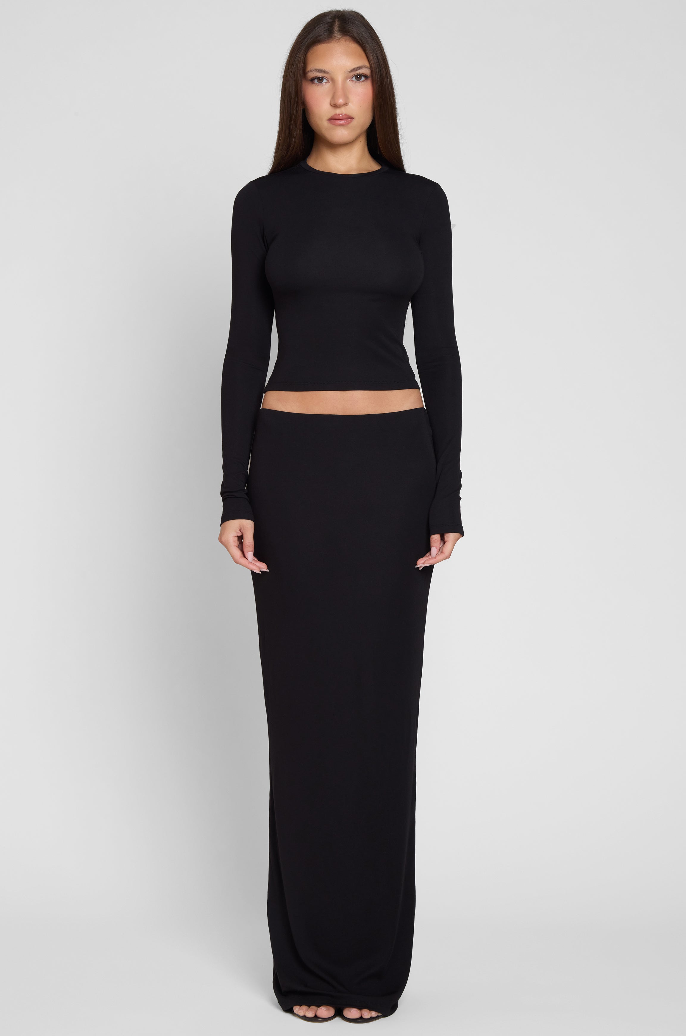 Model is wearing Everyday Jersey Maxi Skirt in Black, front view.