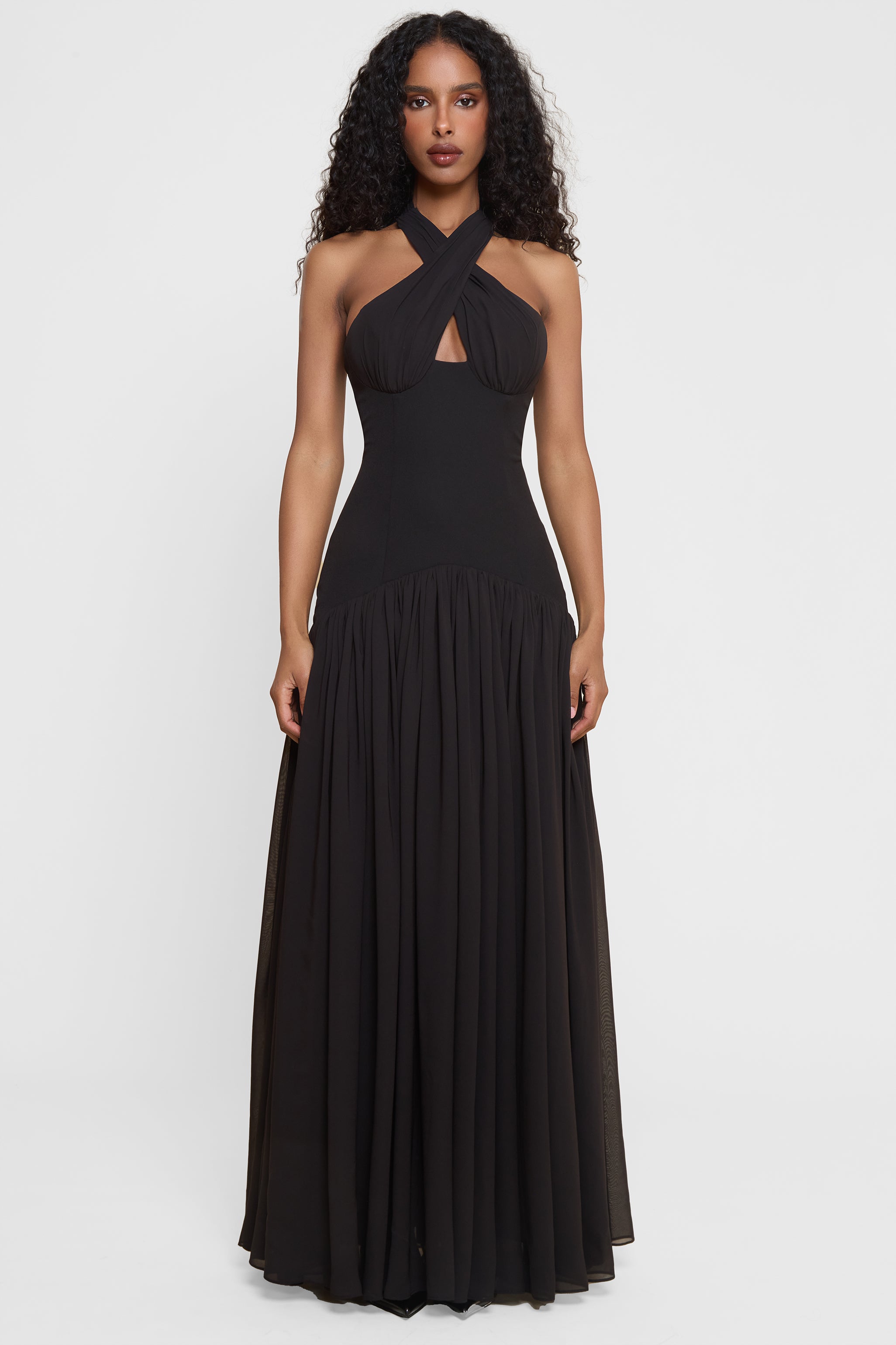 Model wearing Harmony Halter Corset Maxi Dress in Black, front view.