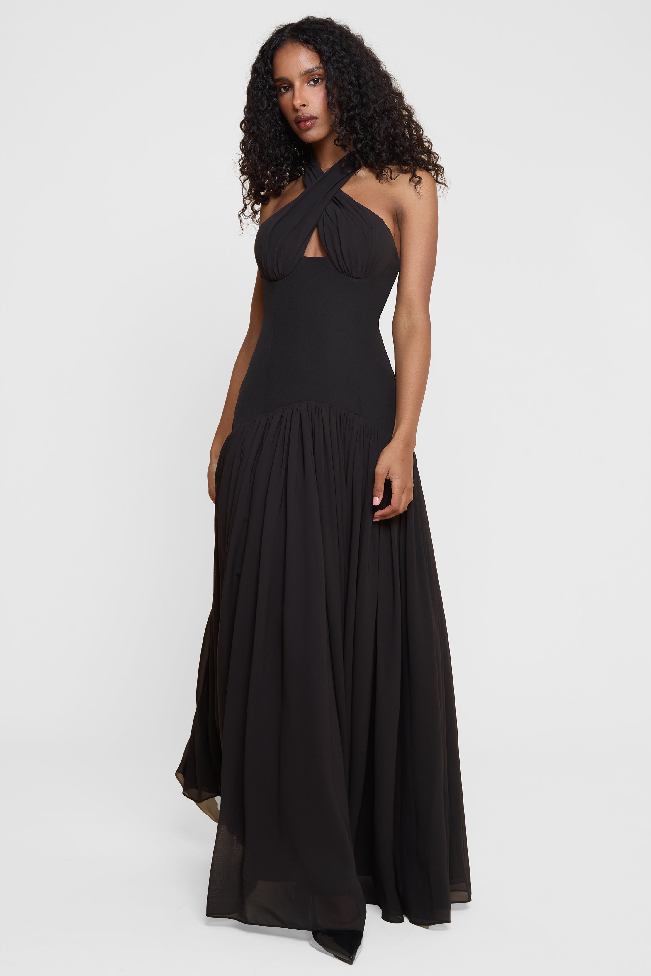 Model wearing Harmony Halter Corset Maxi Dress in Black, front view.