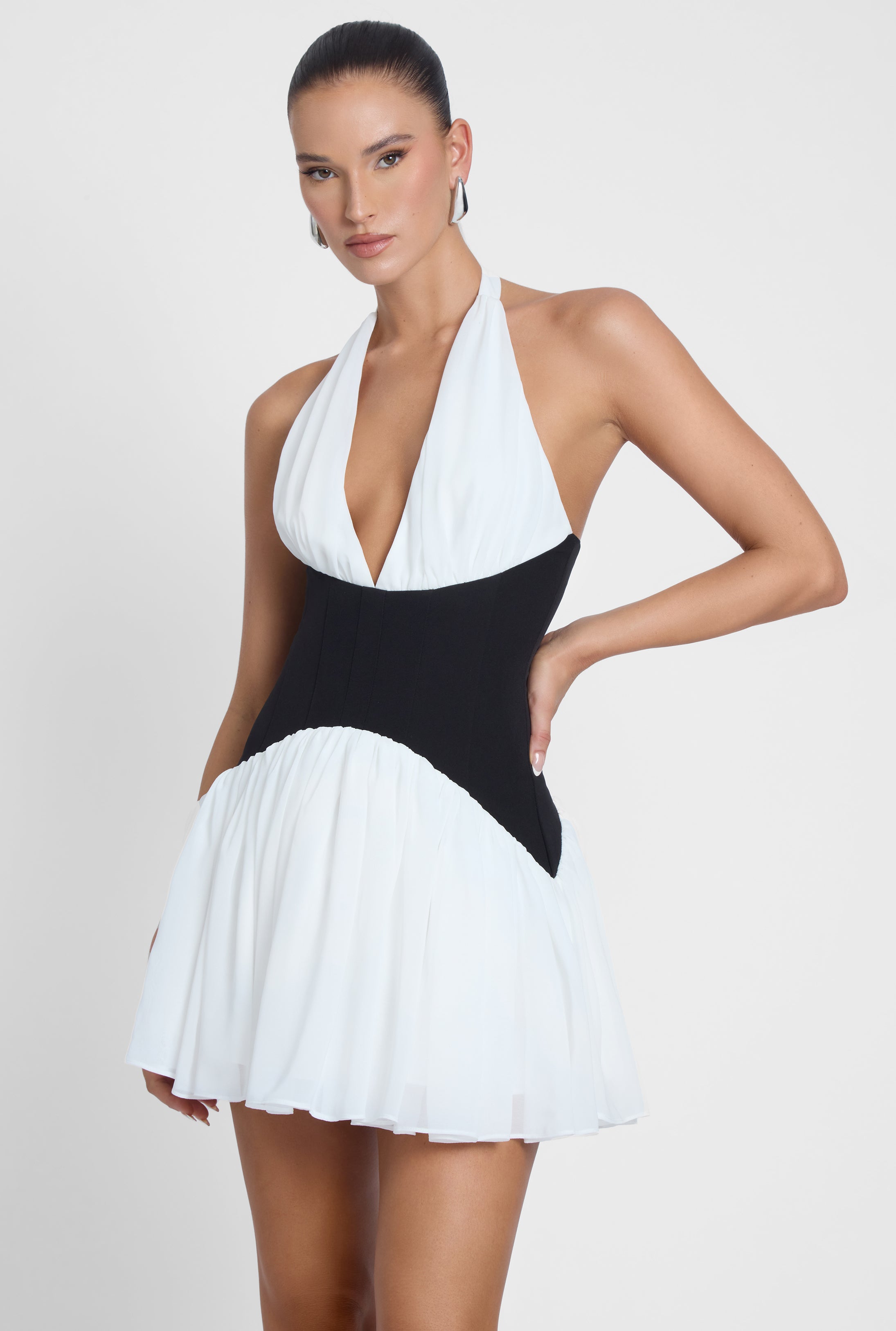 Model is wearing Harper Contrast Corset Mini Dress White, side view.