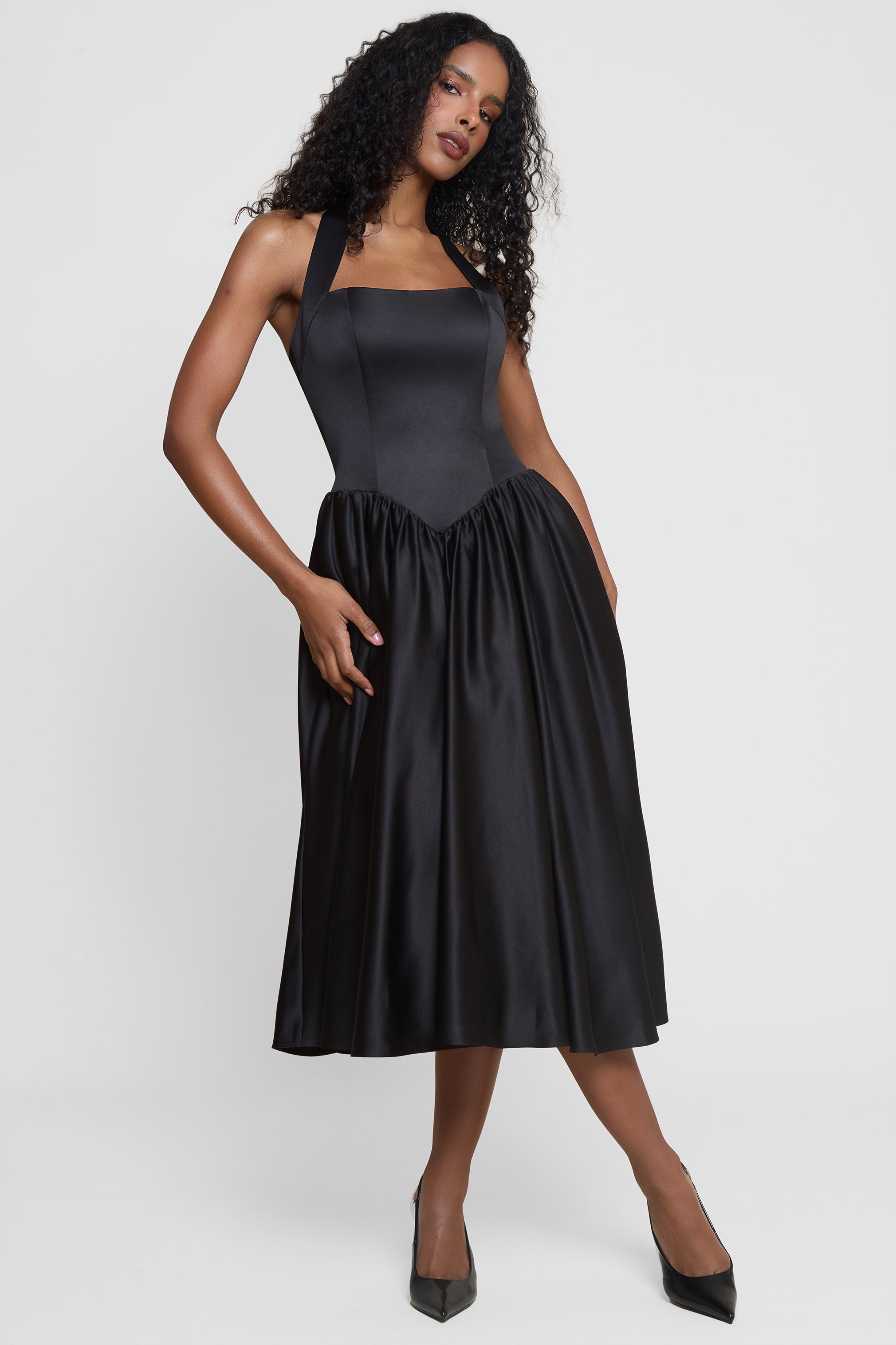 Model wearing Hart Halter Corset Midi Dress in Black, front view