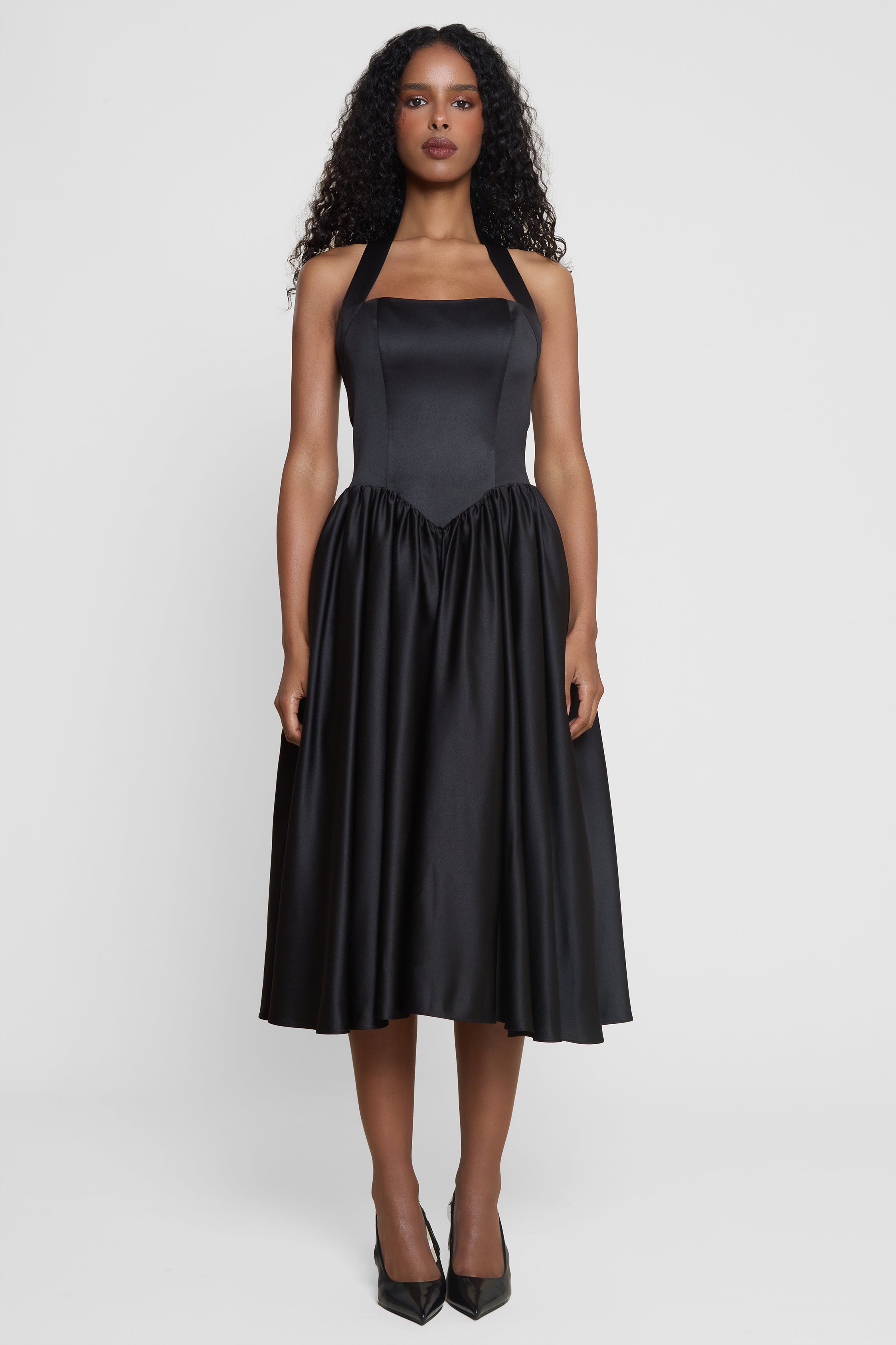 Model wearing Hart Halter Corset Midi Dress in Black, front view