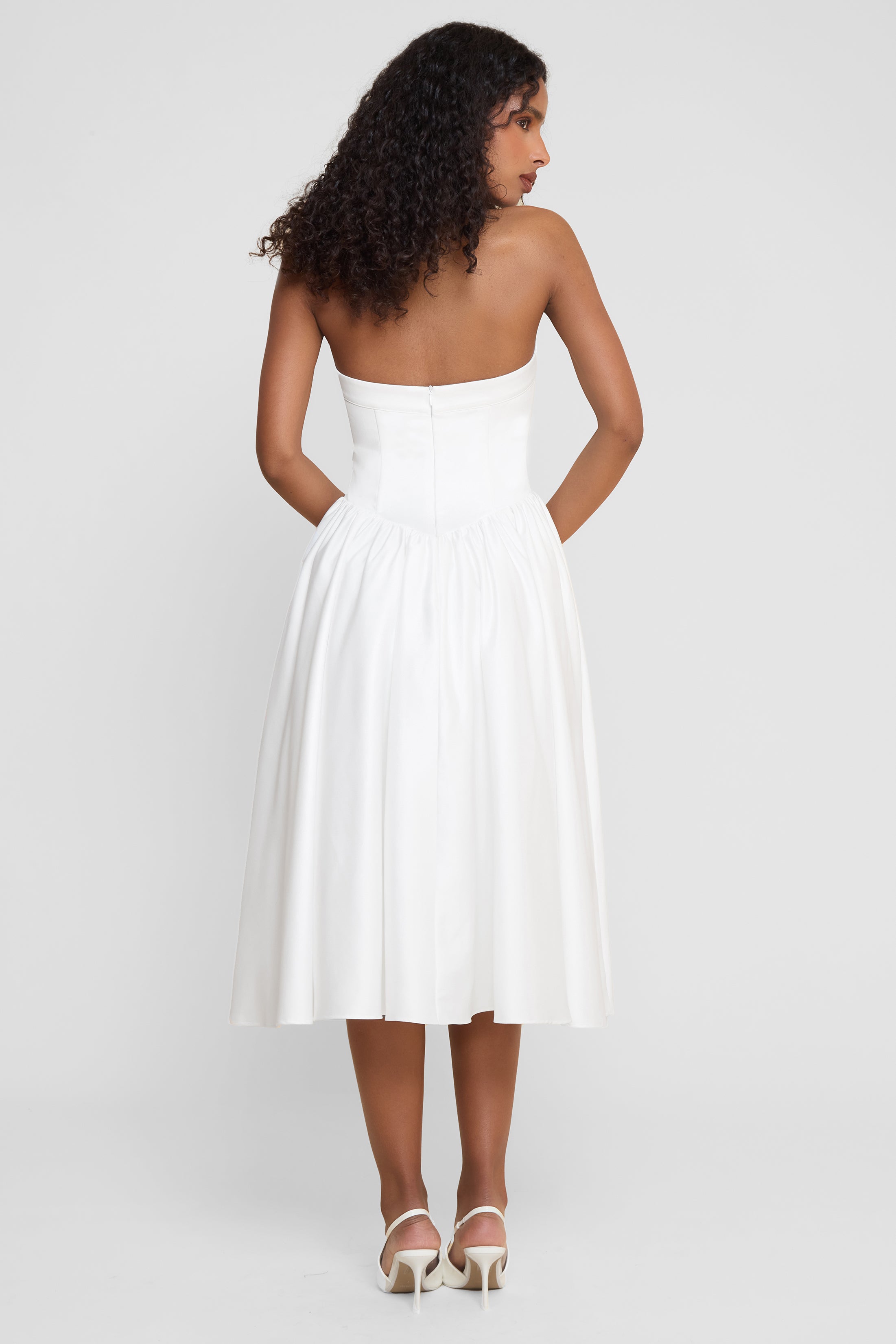 Model wearing Hart Halter Corset Midi Dress in White, back view