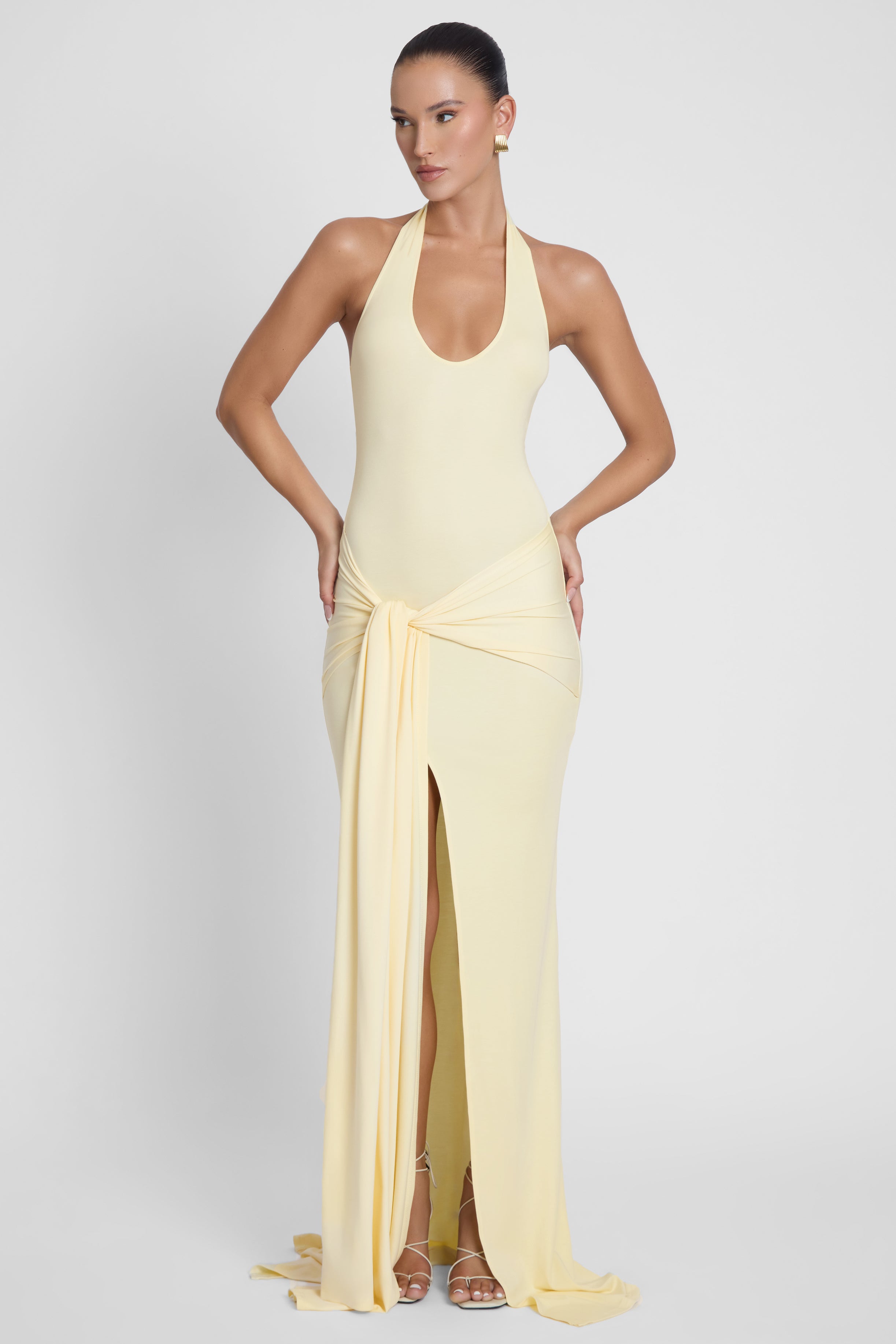 Model is wearing Heaven Halter Jersey Knot Maxi Dress Yellow, front view.