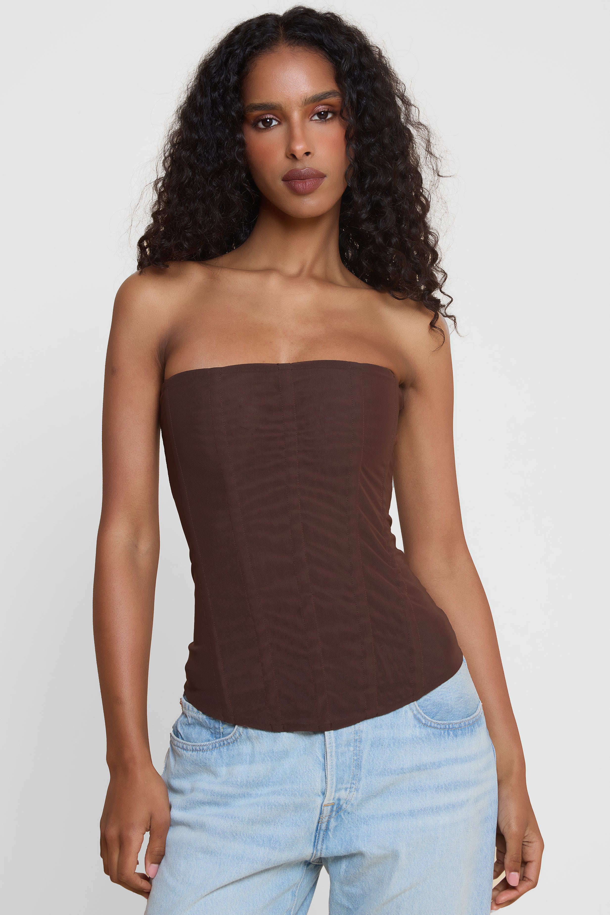 Model wearing Muse Mesh Corset Top in Chocolate Brown, front view.