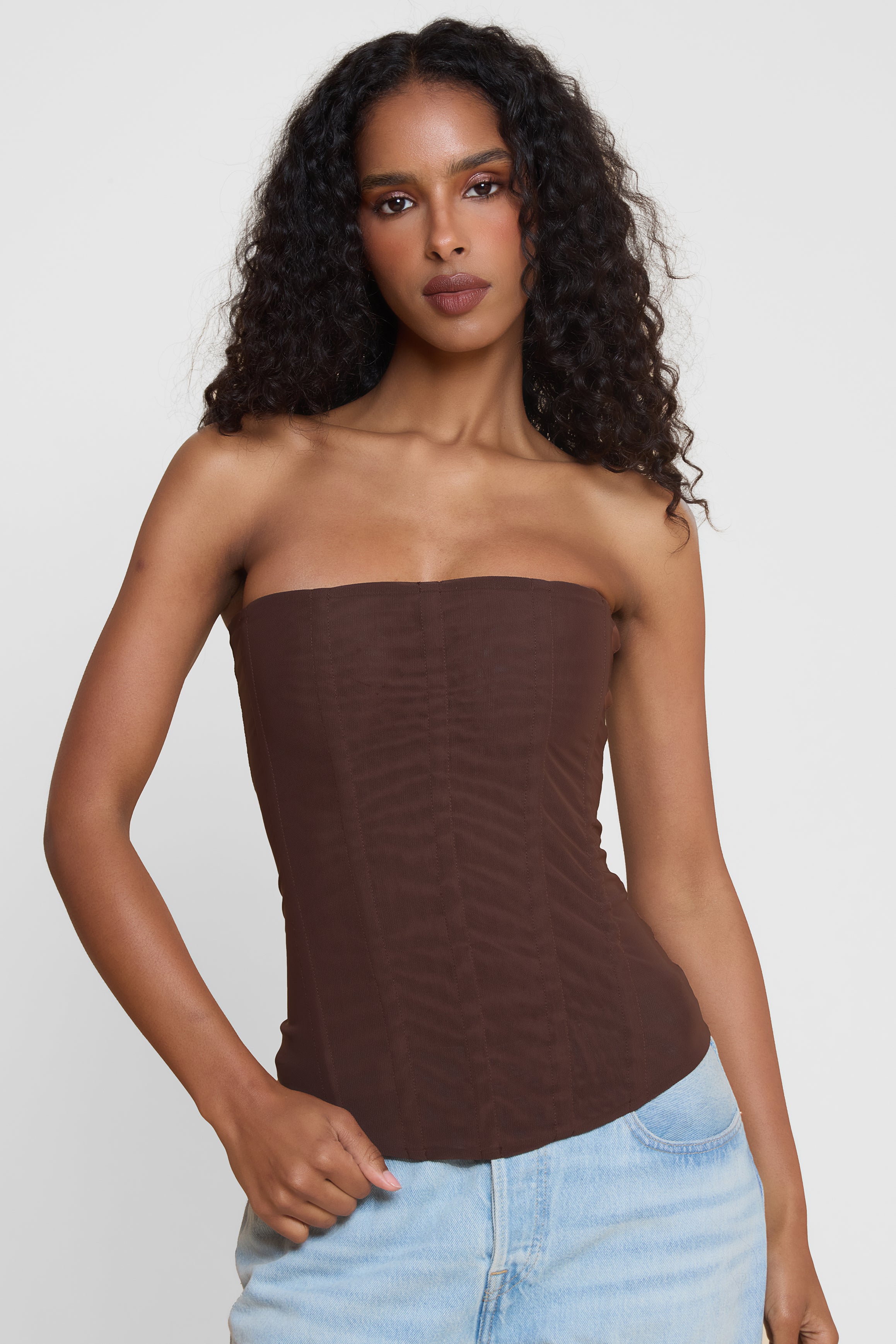 Model wearing Muse Mesh Corset Top in Chocolate Brown, front view.