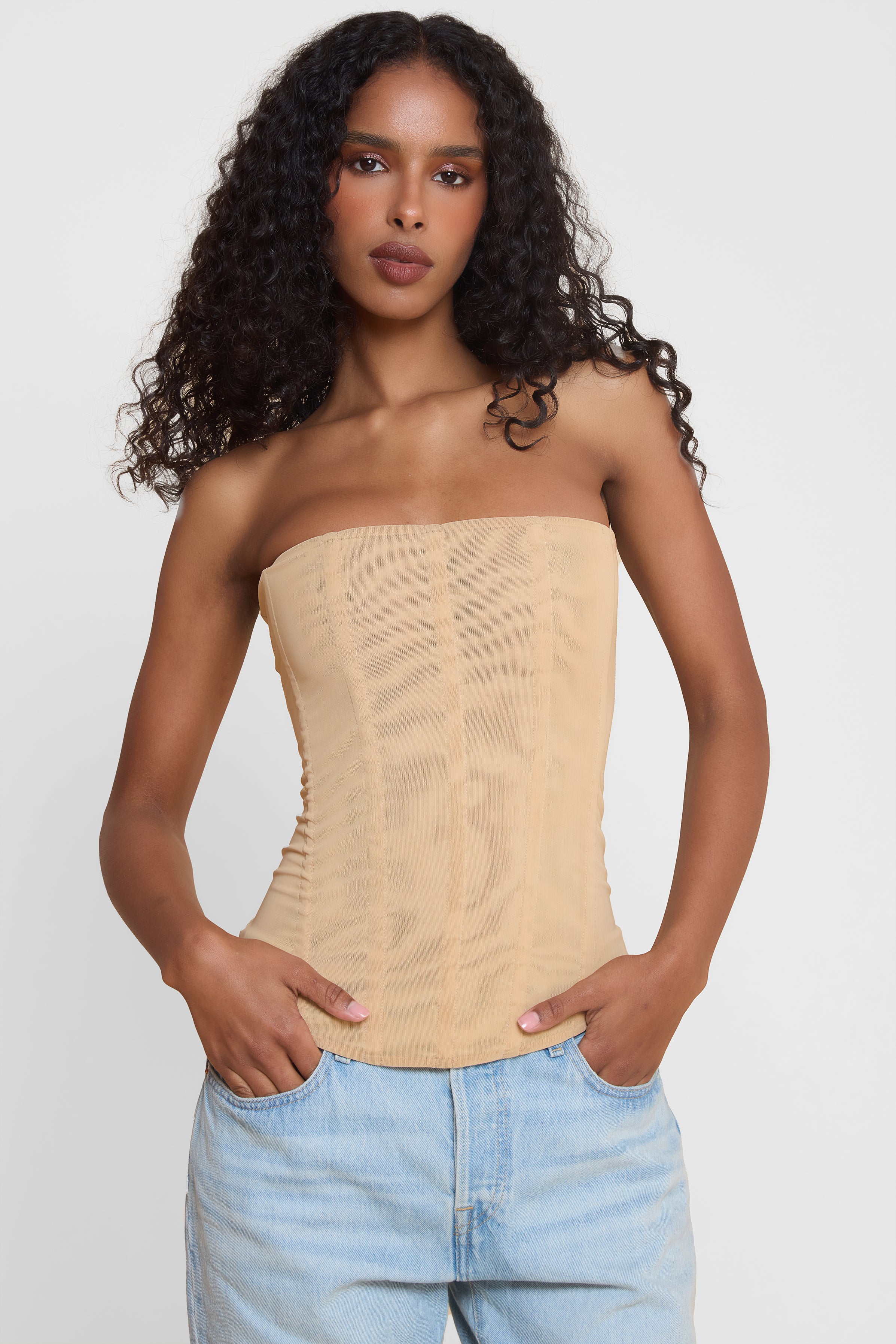 Model wearing Muse Mesh Corset Top in Tan, front view.
