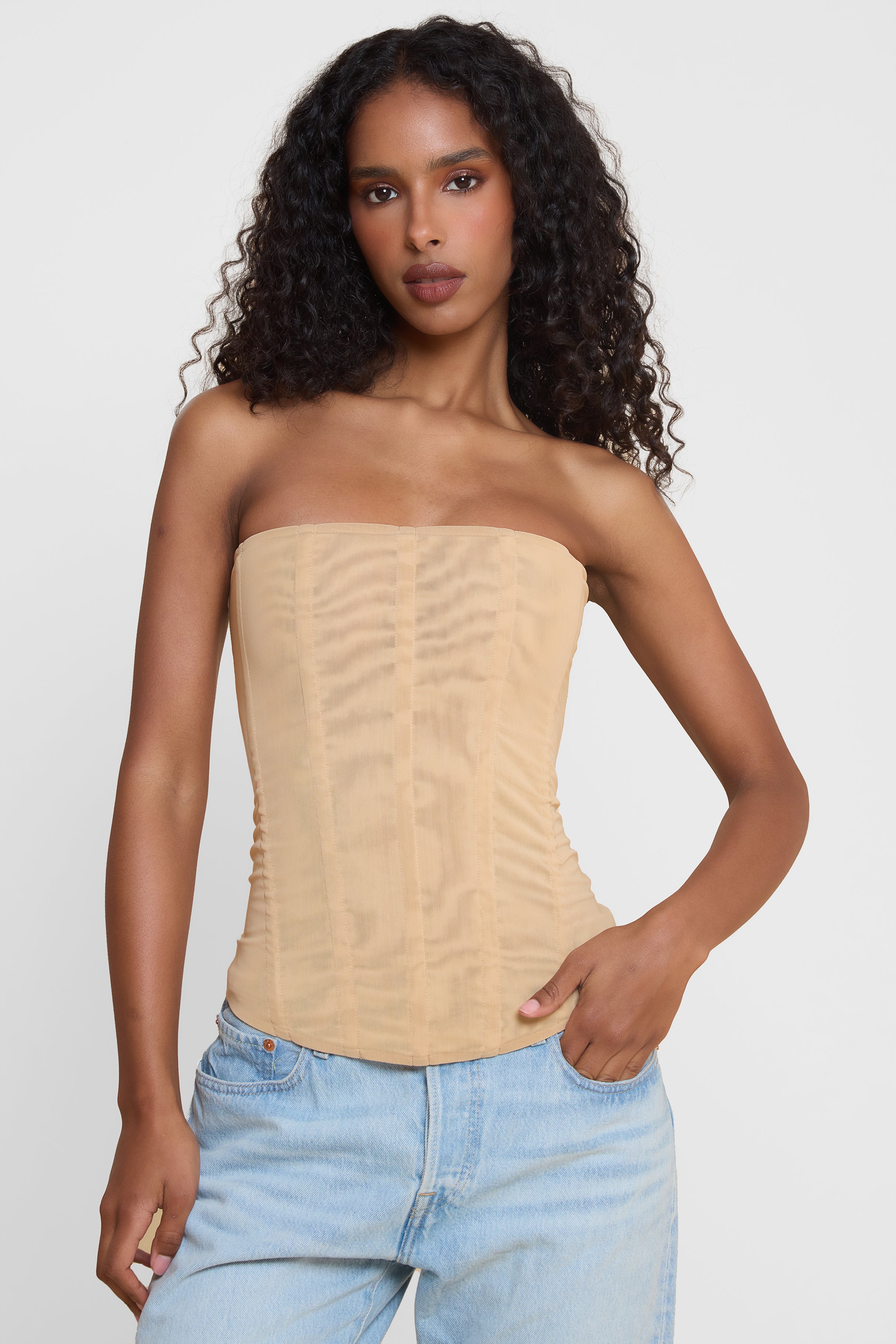 Model wearing Muse Mesh Corset Top in Tan, front view.