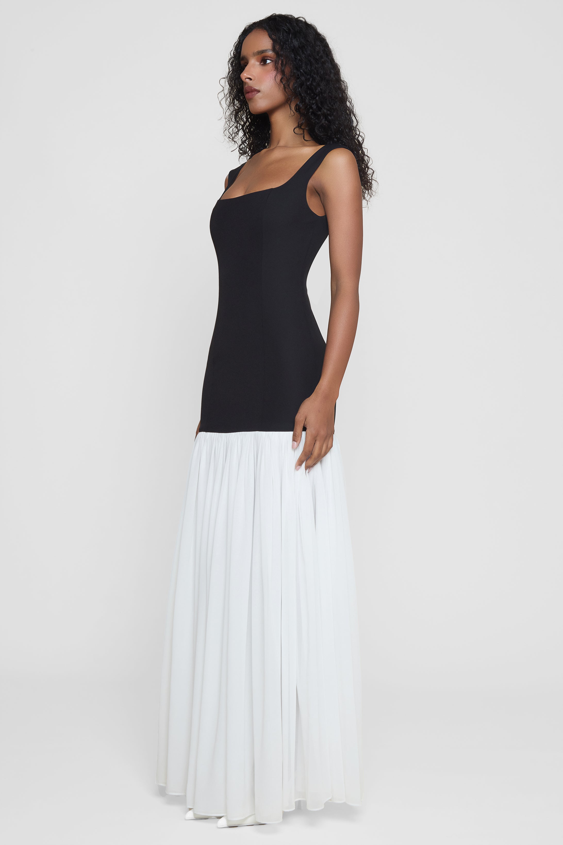 Model wearing Phantom Contrast Chiffon Maxi Dress in Black/White, side view.
