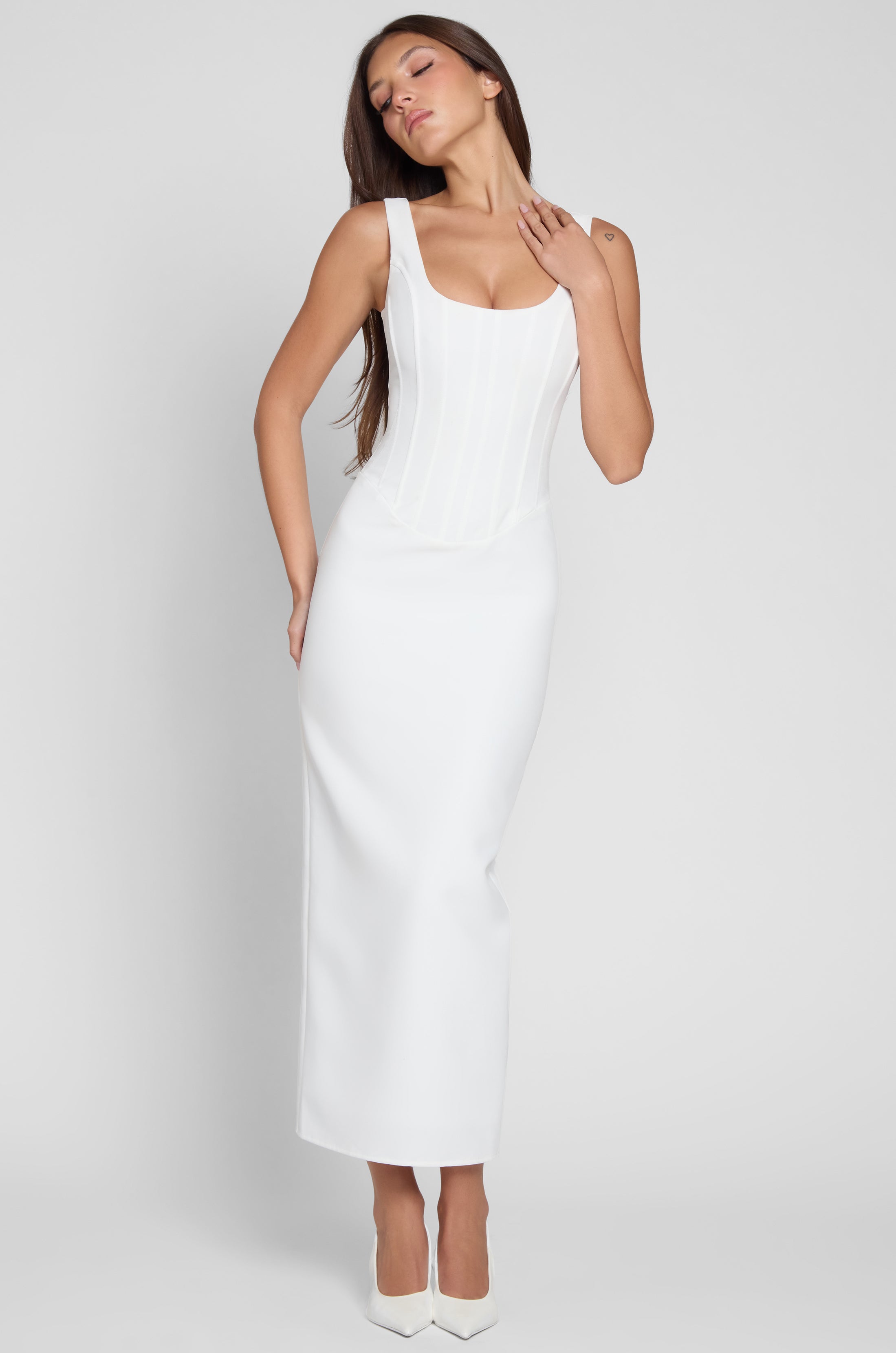 Model wearing Sancia Corset Midi Dress in White, front view.