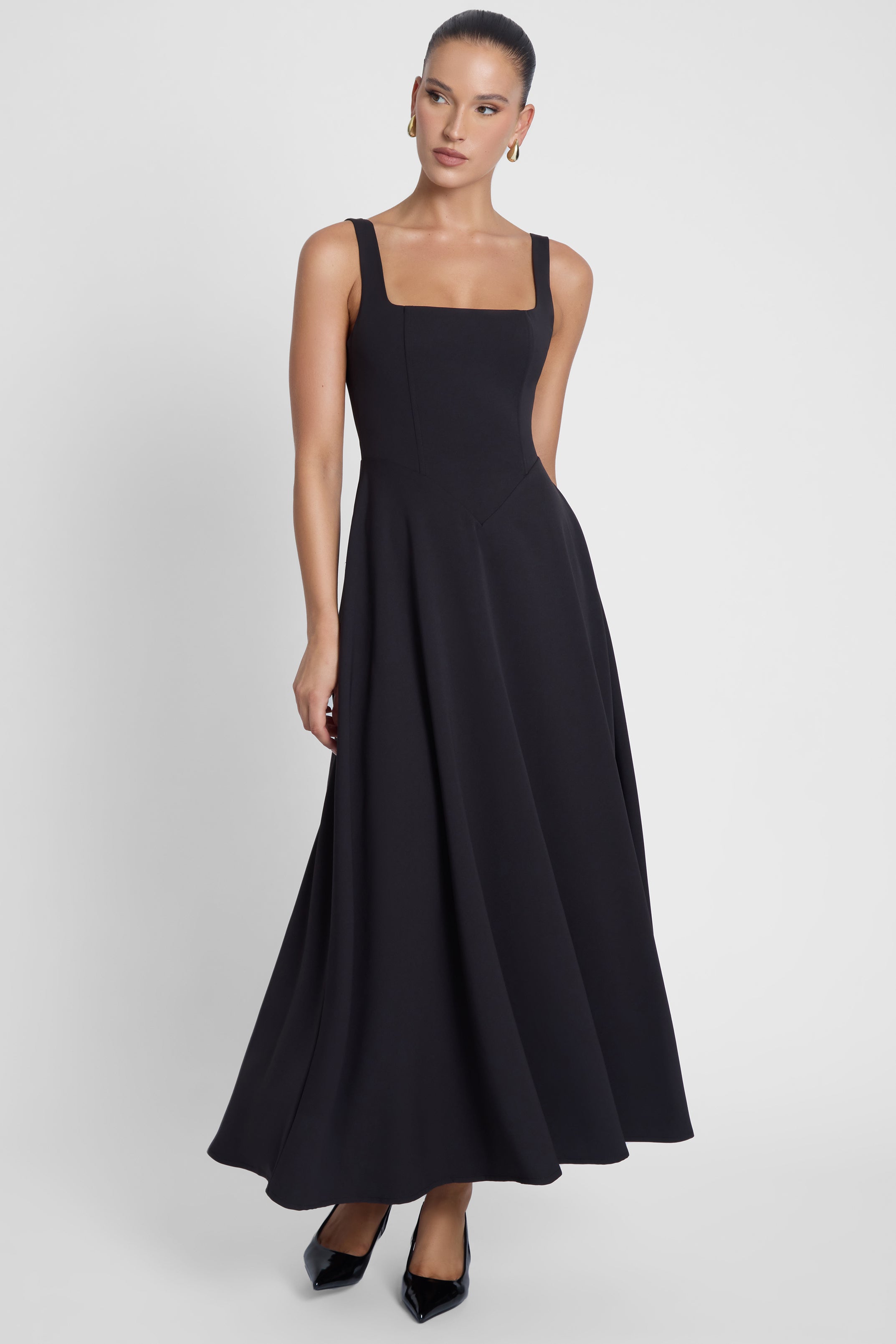 Model is wearing Serenity Square Neck Corset Midi Dress Black, front view.