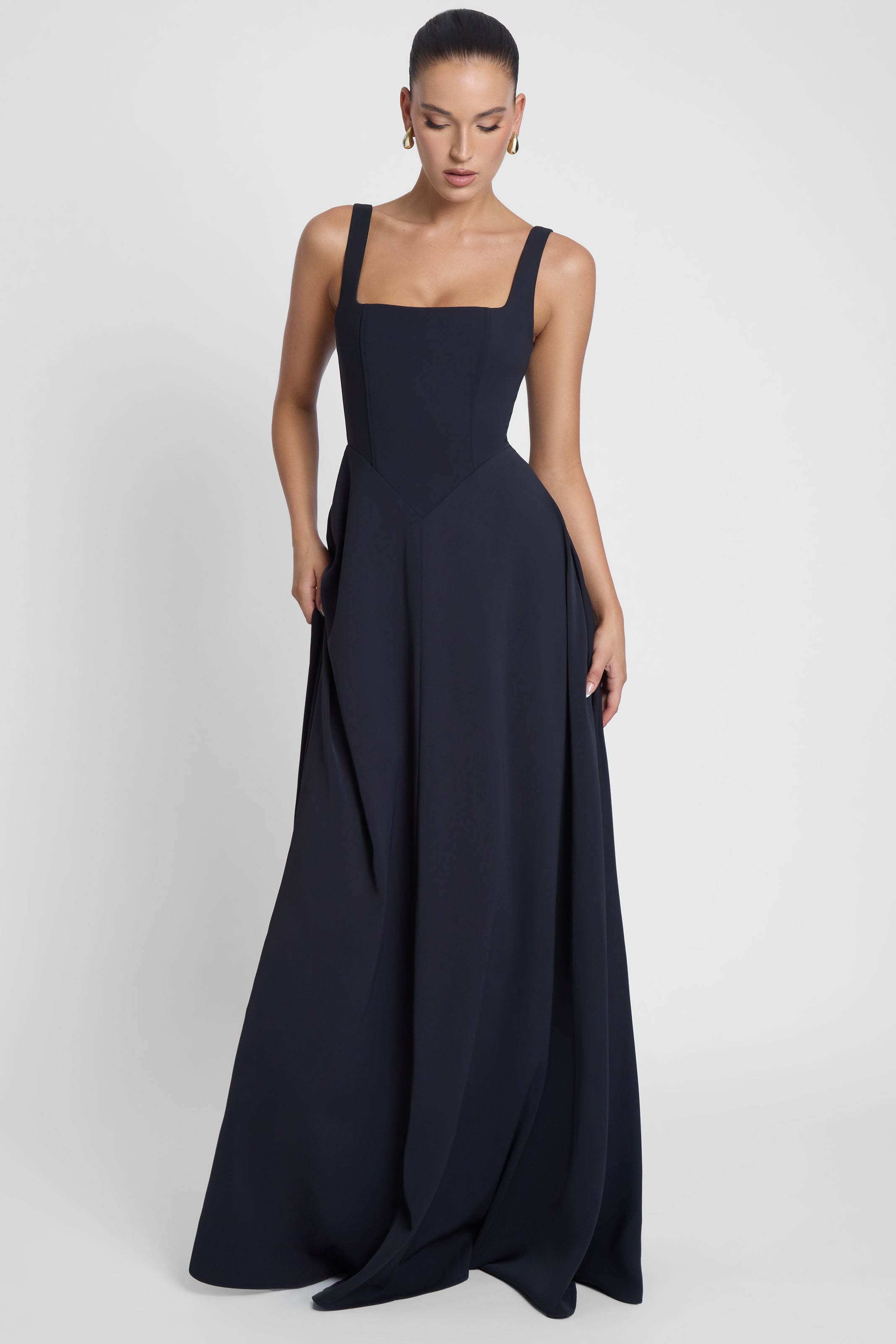 Model is wearing Siren Square Neck Corset Maxi Dress Black, front view.