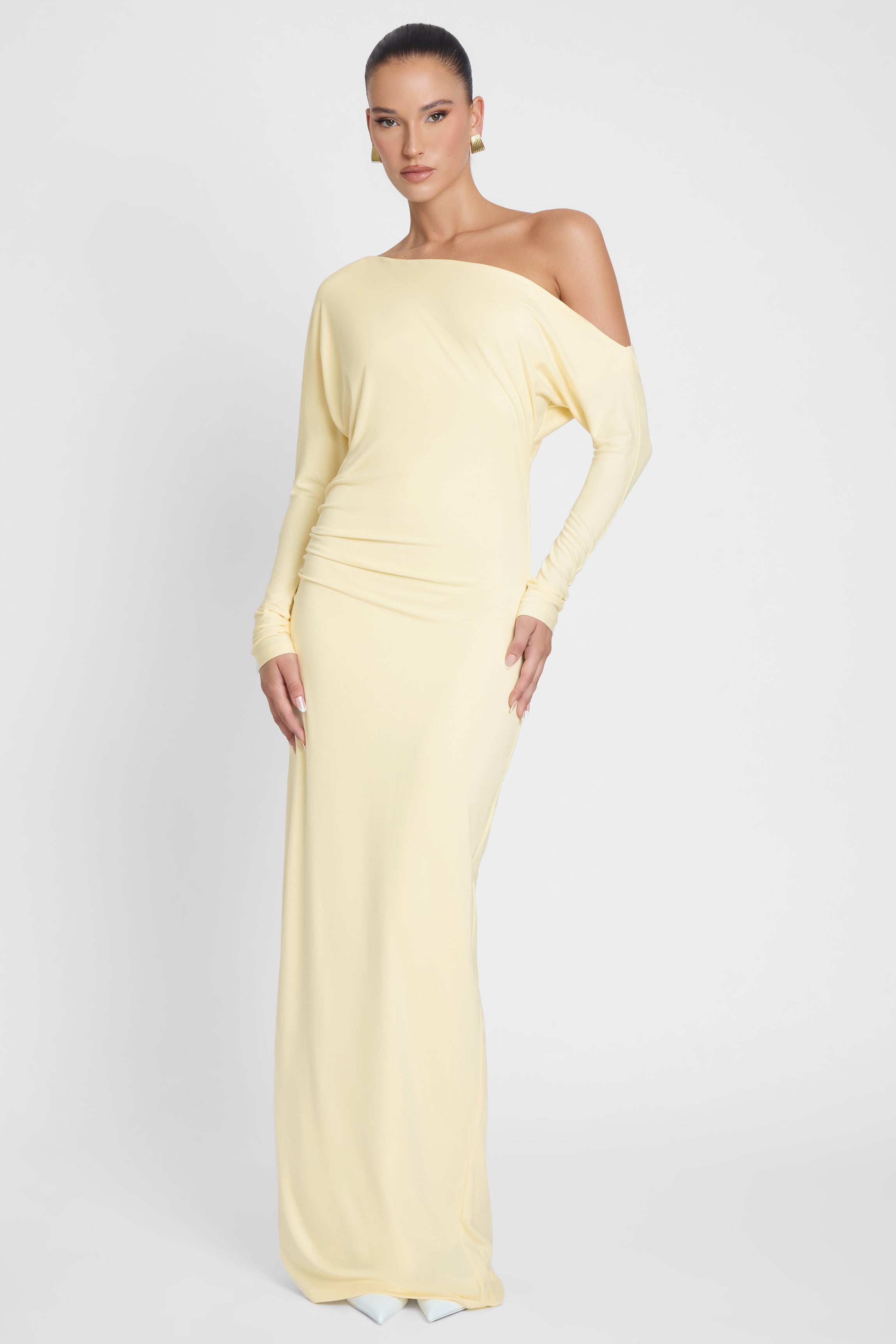 Model is wearing Sola Slouchy Jersey Maxi Dress Yellow, front view.