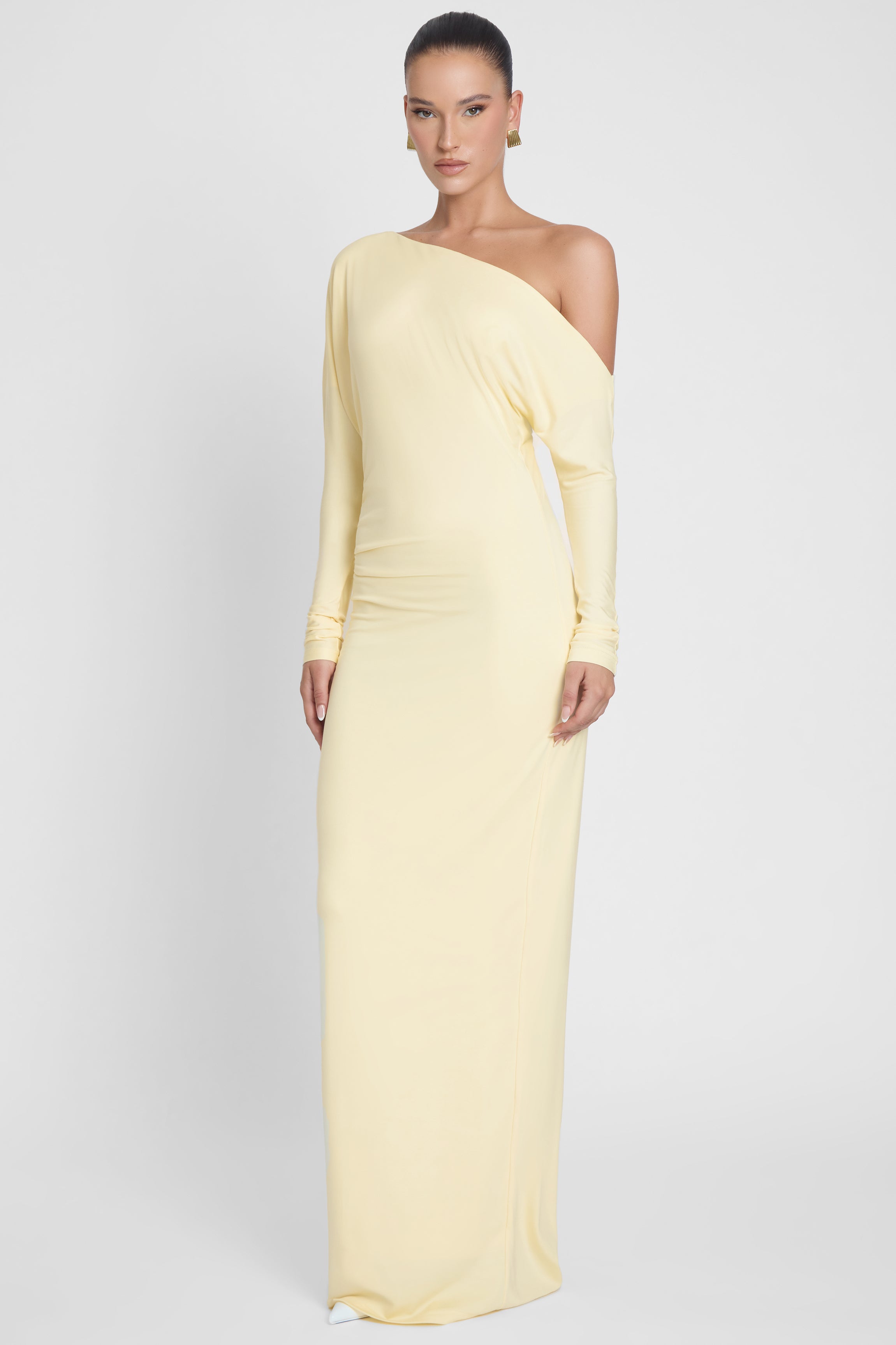 Model is wearing Sola Slouchy Jersey Maxi Dress Yellow, front view.
