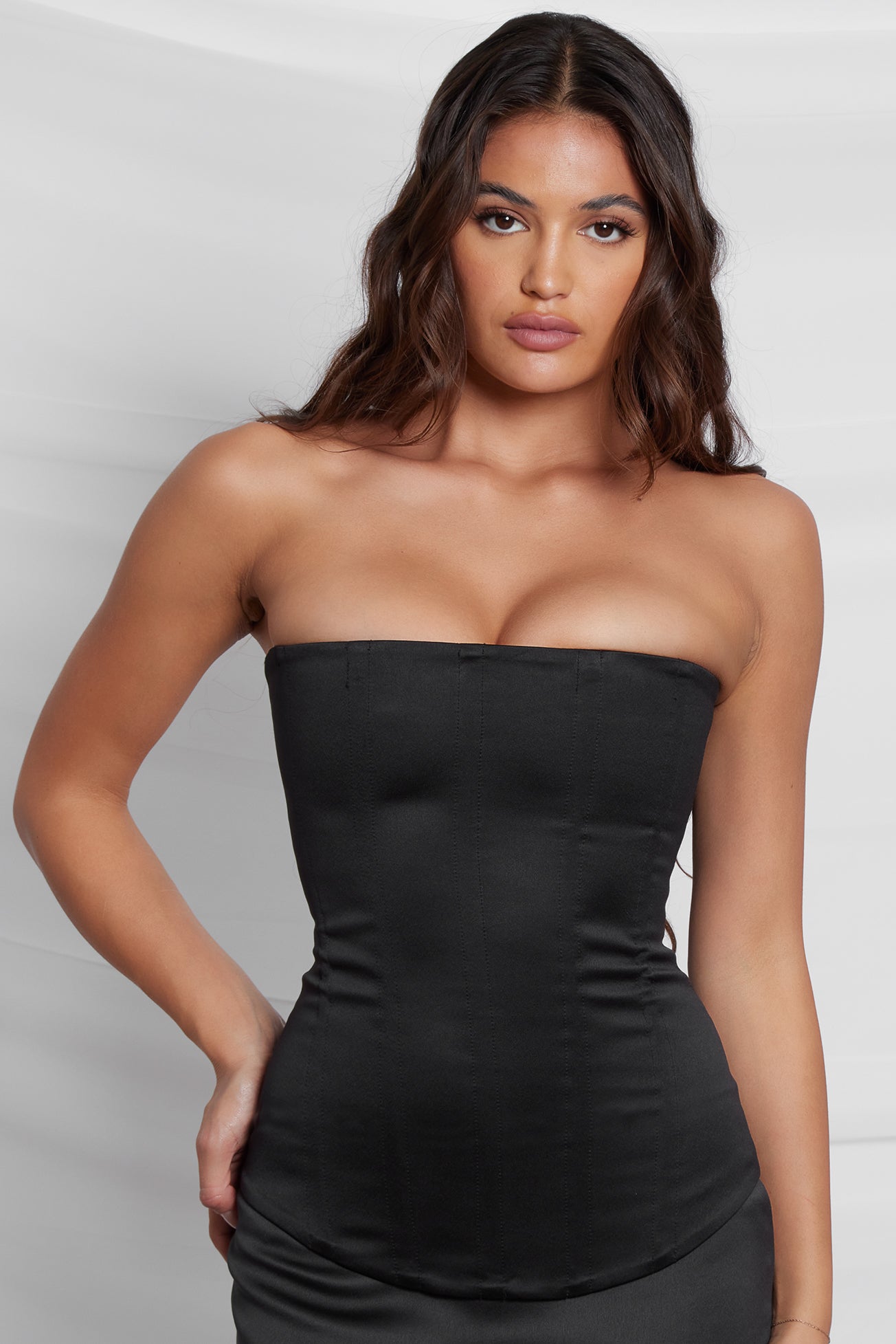 Model wearing Sphynx Satin Corset Top in Black, front view.