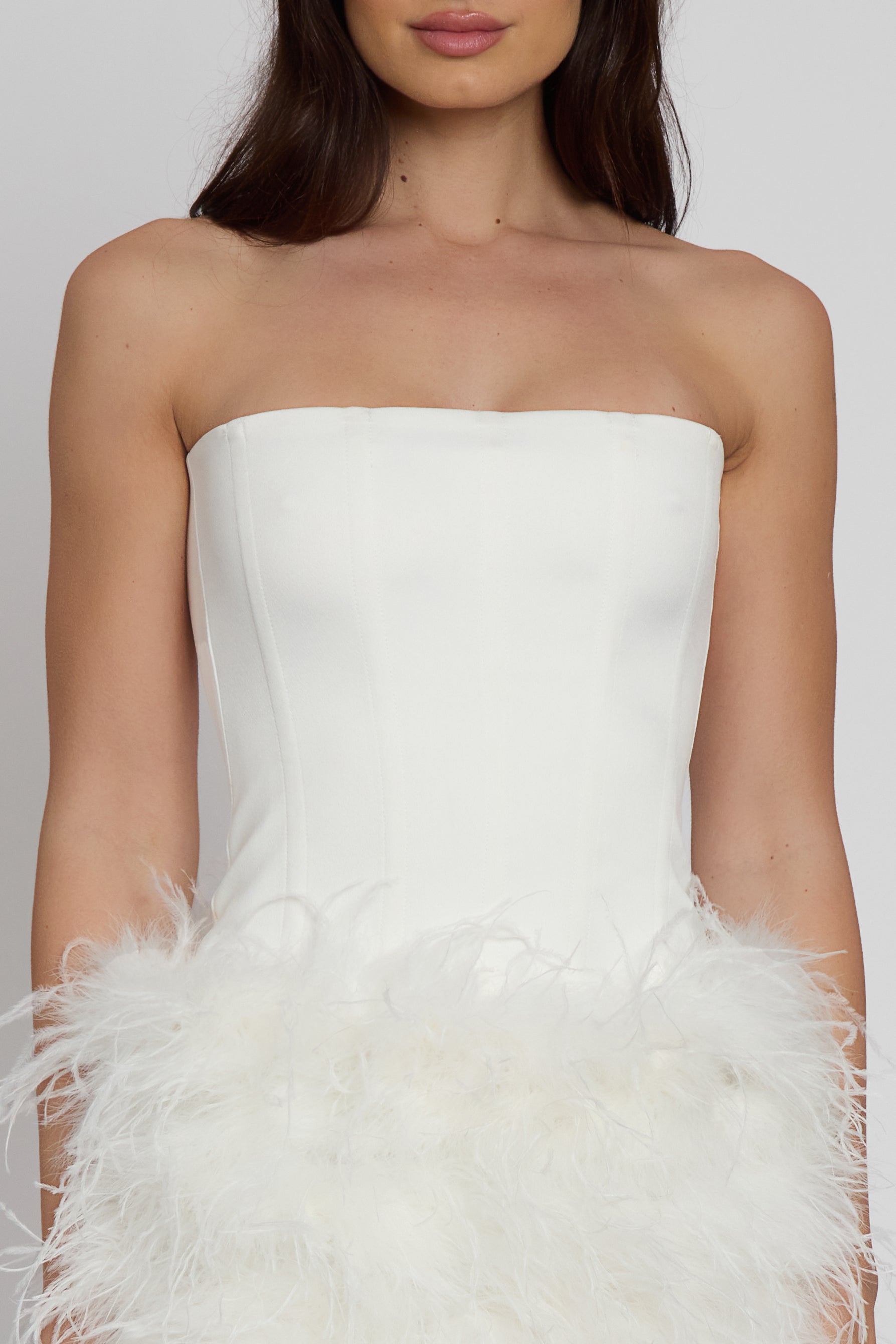 Model wearing Sphynx Satin Corset Top in White, front view.