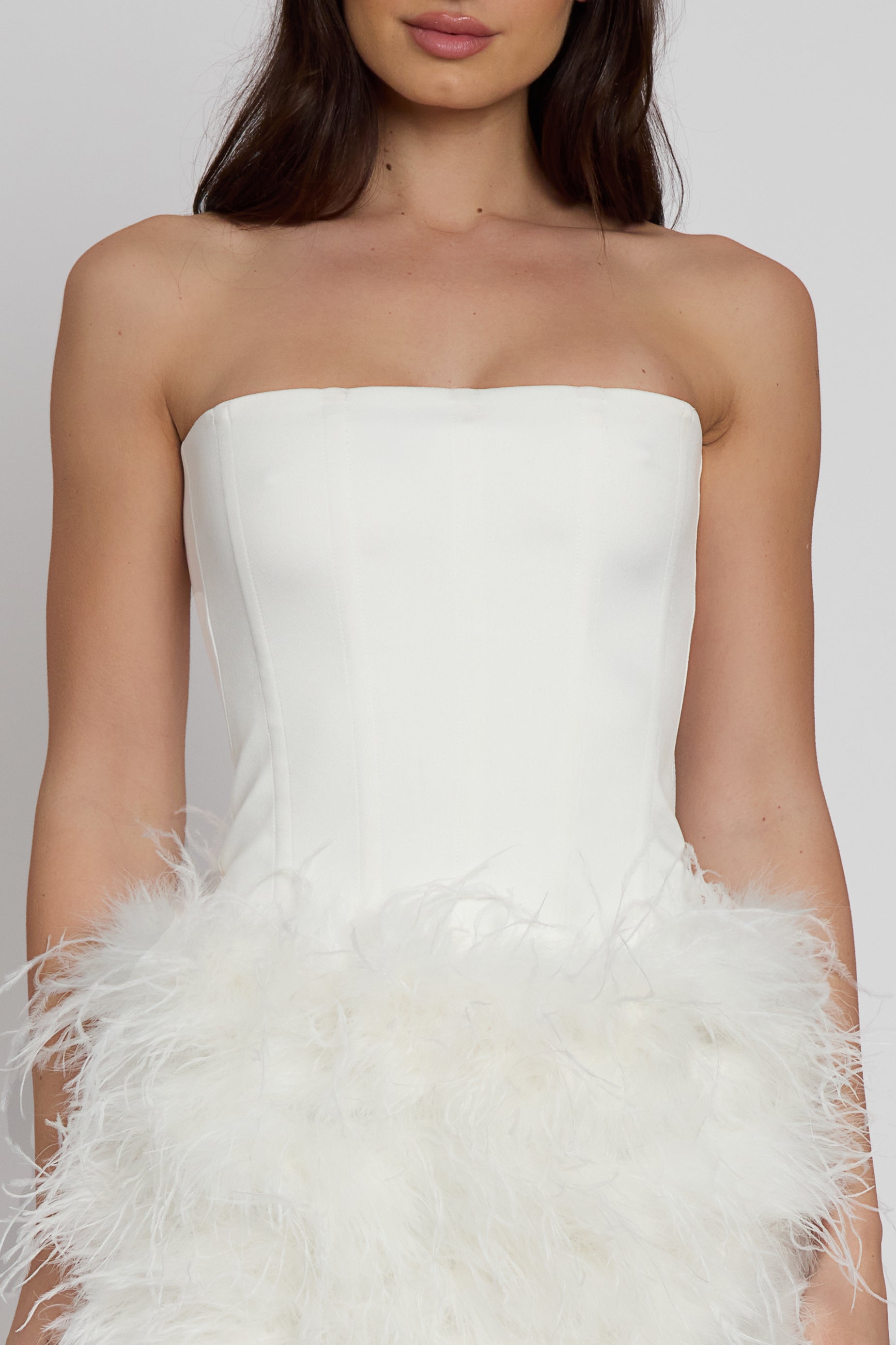 Model wearing Sphynx Satin Corset Top in White, front view.