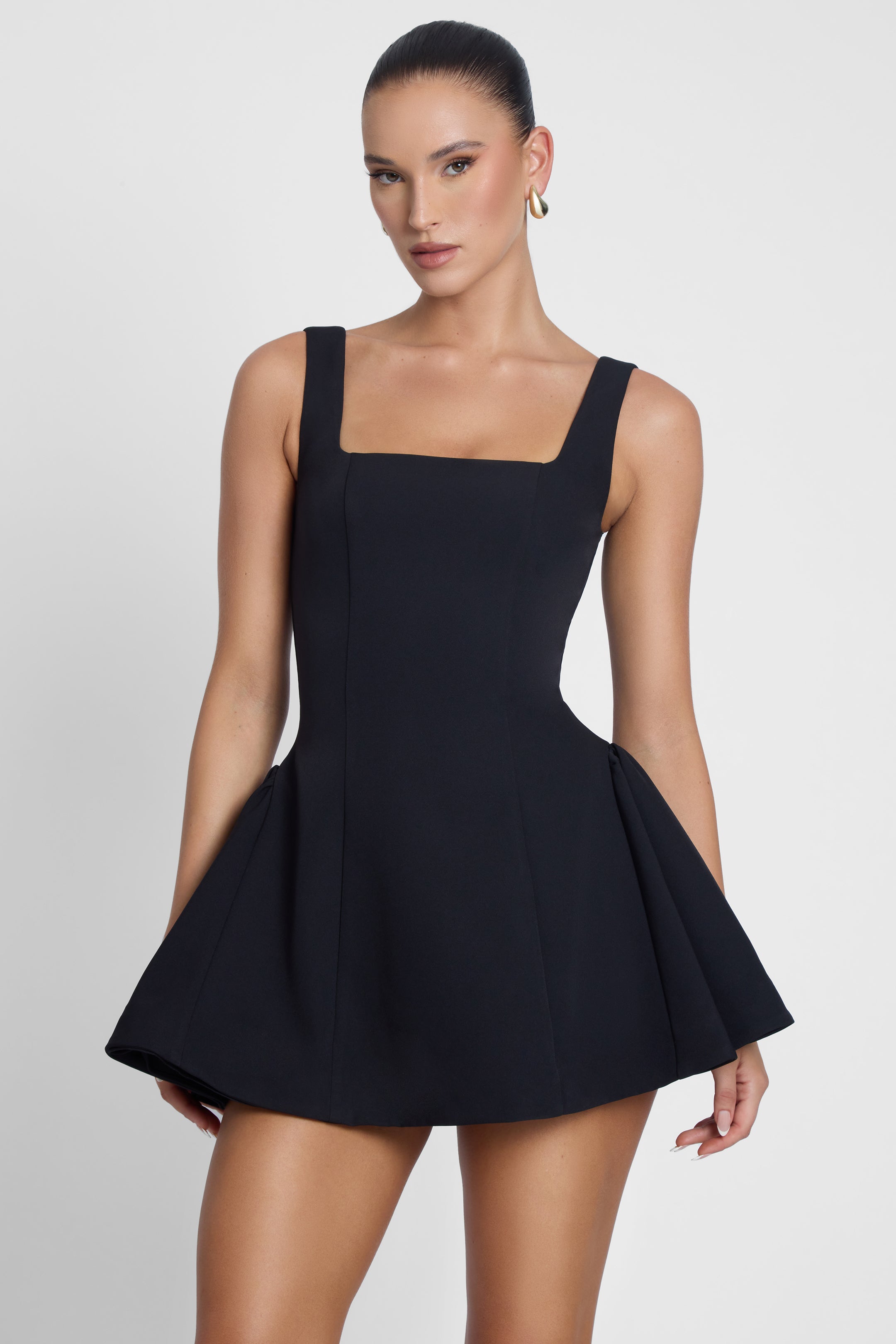 Model is wearing Ysabelle Babydoll Corset Mini Dress Black, front view.